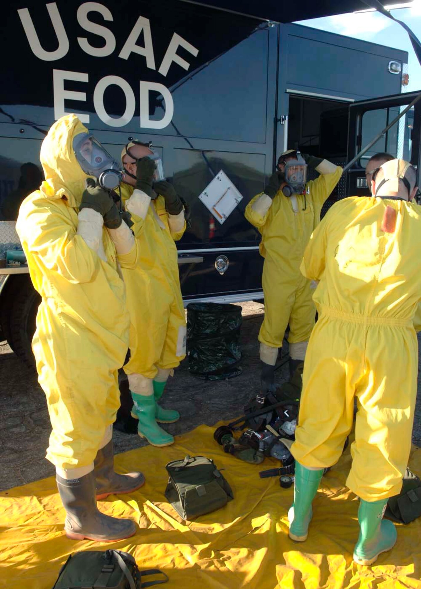 Airman from the explosive ordnance disposal team prepare their masks and radiological suits prior to the initial setup entry procedures before going to search the wreakage of a simulated aircraft accident Dec. 4 at Davis-Monthan AFB, Ariz. Exercise Vigilant Shield 07 is a joint Department of Defense and federal nuclear weapon accident exercise. The exercise scenario involved a C-17 Globemaster III carrying four nuclear weapons to be diverted to Davis-Monthan AFB due to simulated engine failure that caused an aircraft accident. Sergeant Swann is an explosive ordnance disposal journeyman from the 355th Civil Engineering Squadron. (U.S. Air Force photo/Senior Airman Christina D. Ponte)
