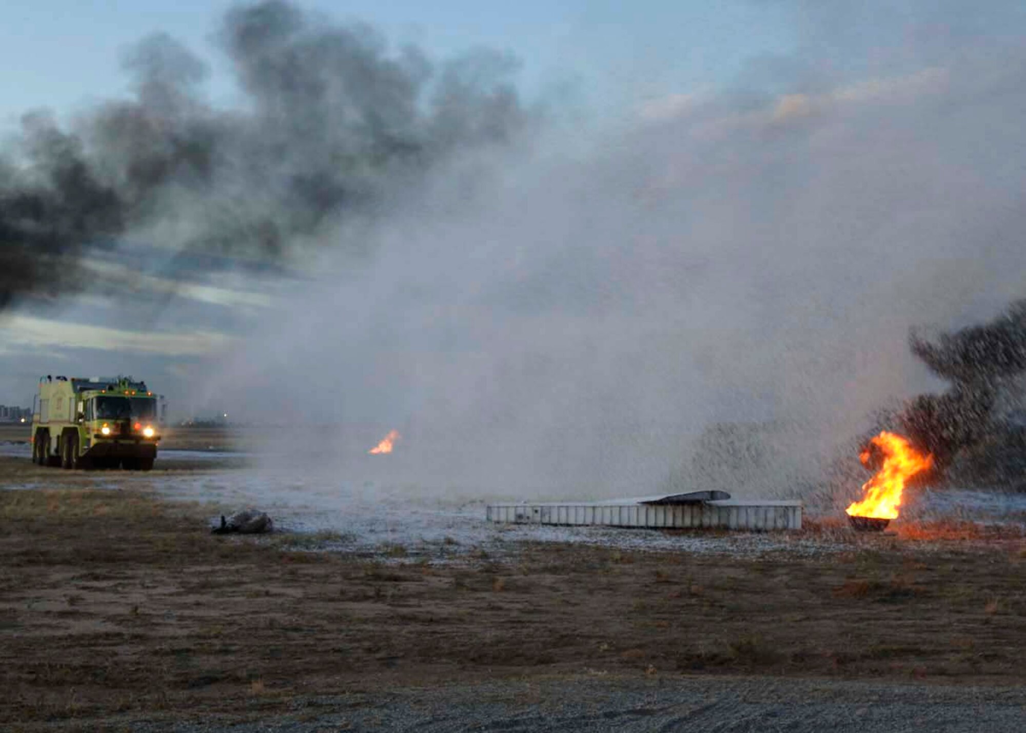Davis-Monthan Air Force Base firefighters put out a fire by the use of foam at a simulated crash site of a C-17 Globemaster III Dec. 4 at Davis-Monthan AFB, Ariz. Exercise Vigilant Shield 07 is a joint Department of Defense and federal nuclear weapon accident exercise. The exercise scenario involved a C-17 carrying four nuclear weapons to be diverted to Davis-Monthan AFB due to simulated engine failure that caused an aircraft accident. Davis-Monthan firefighters, the Tucson Fire Department, Tucson Police Department, and many different agencies ranging form local to national levels responded to the simulated scene. (U.S. Air Force photo/Senior Airman Christina D. Ponte)
