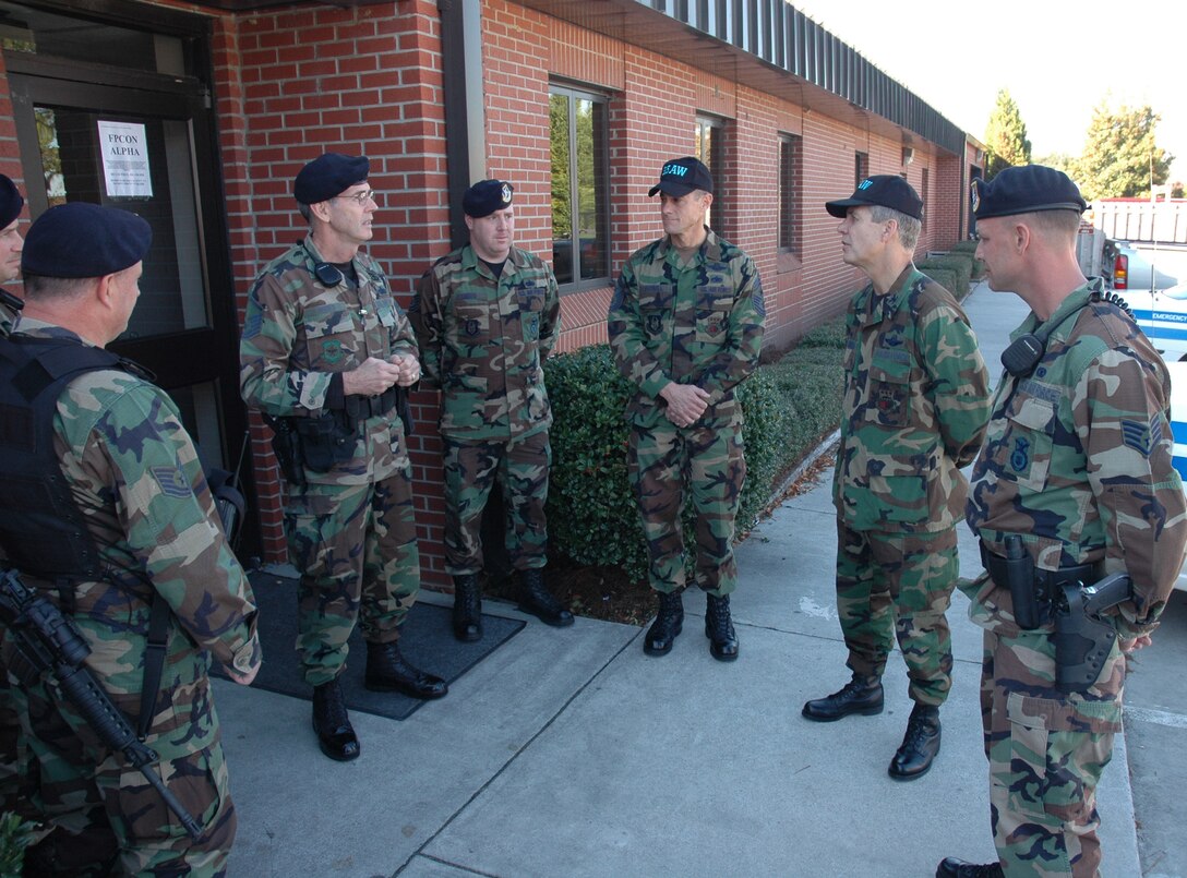 Chief Master Sgt. Ben Futrell (center left), 315th Airlift Wing command chief master sgt., and Col. Tim Wrighton (center right), 315th Airlift Wing commander, meets some of the Air Force Reserve Security Force members at their Guardmont roll call. (photo by Tech. Sgt. Mark Kleber)
