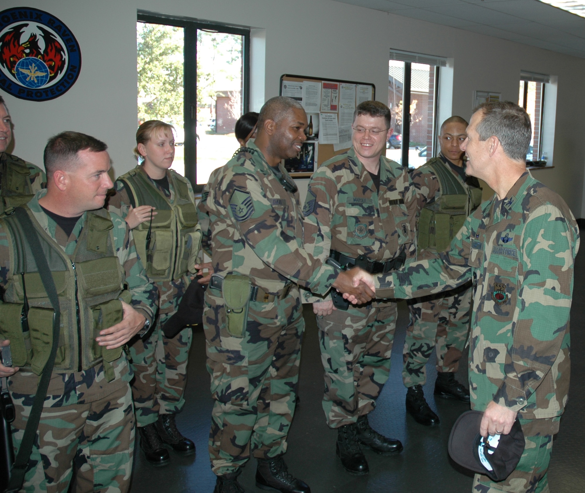 Col. Tim Wrighton, 315th Airlift Wing commander, shakes the hand of a reserve sercurity forces augmentee during the Security Forces Guardmont roll call. (photo by Tech. Sgt. Mark Kleber)
