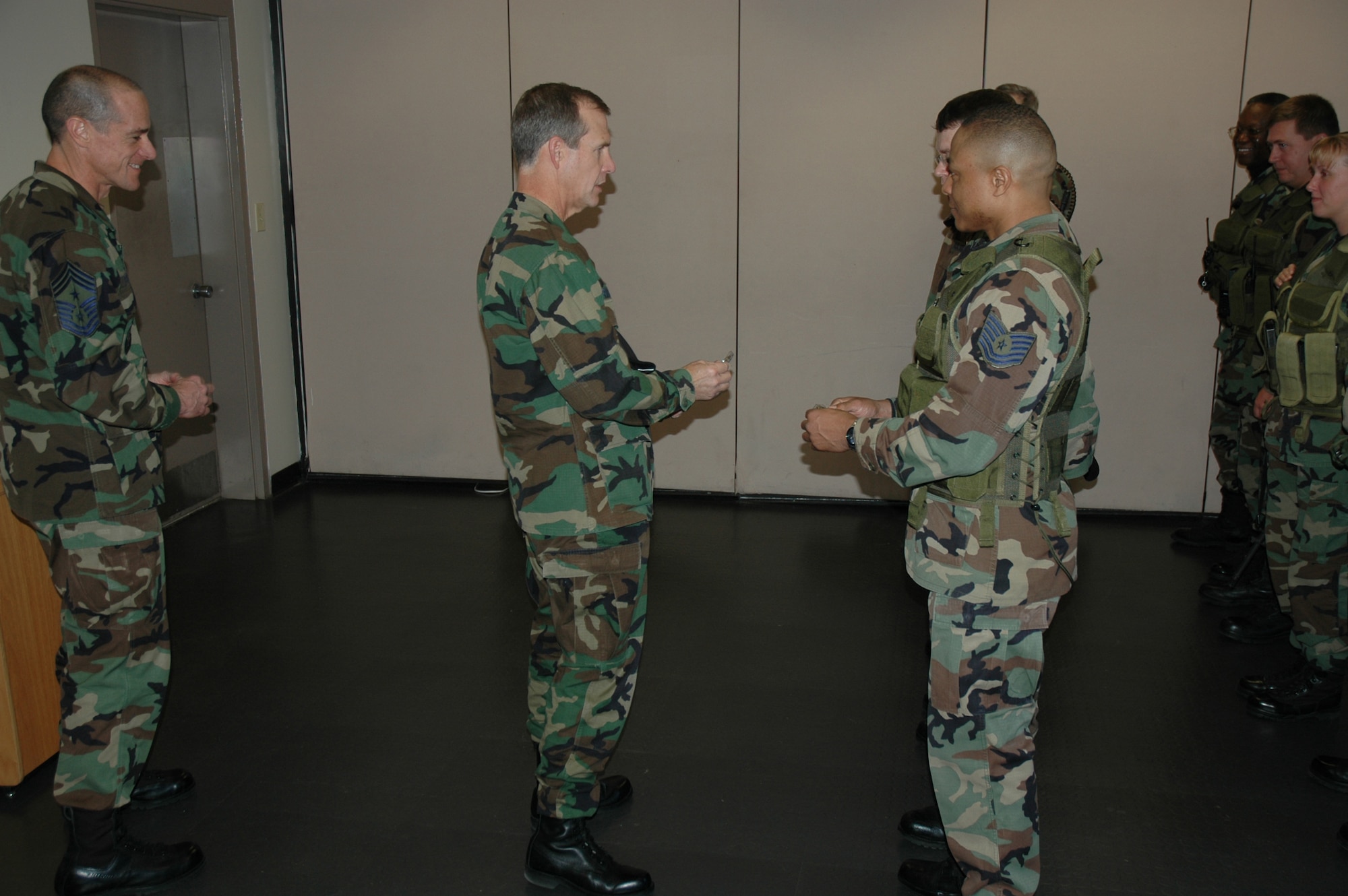 Chief Master Sgt. Ben Futrell (center left), 315th Airlift Wing command chief master sgt., and Col. Tim Wrighton (center right), 315th Airlift Wing commander, meets some of the Air Force Reserve Security Force members at their Guardmont roll call. (photo by Tech. Sgt. Mark Kleber)