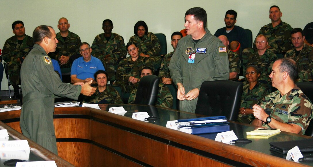 482nd Fighter Wing Commander Col. Randy Falcon (left) speaks with inspection team chief Col. Ian O’ Connell during the out brief Nov. 5 at the Heritage Hall Conference Center. Members of the inspection team and base personnel were present to hear the results. (U.S. Air Force photo/Master Sgt. Ray Sarracino)