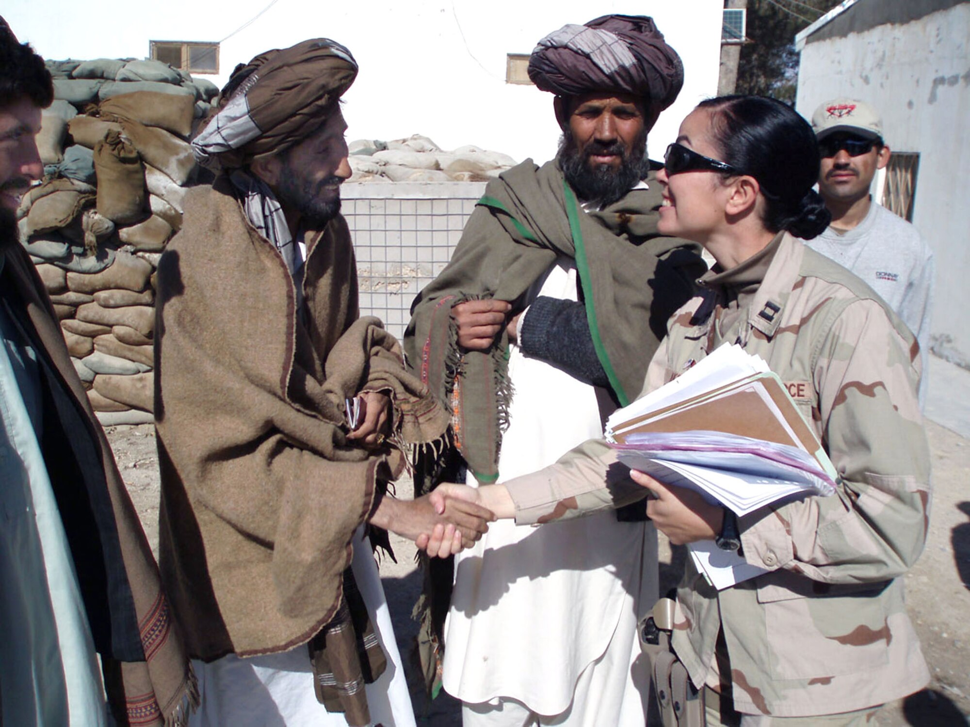 Capt. Aine Akeley meets local contractors who attended the first Qalat Vendor's Fair Nov. 26 in Qalat, Afghanistan.  Forty contractors from the Zabul Province attended the event. Captain Akeley is the services and commodities chief for the Regional Contracting Center. (U.S. Air Force photo/Capt. Kevin G. Tuttle)