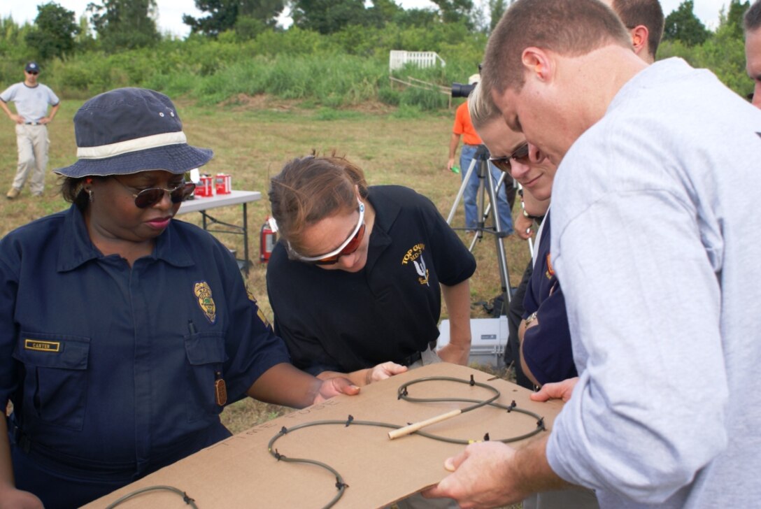 More than 30 crime scene investigators from the Broward Sherriff’s Office and the City of Miami and Miami-Dade police departments attended the FBI’s post-blast forensics training Nov. 8 and 9 here at Homestead Air Reserve Base, Fla. FBI agents gave students an up-close look at methods used to set off explosives, such as timed detonation cords. (U.S. Air Force photo/Dan Galindo)