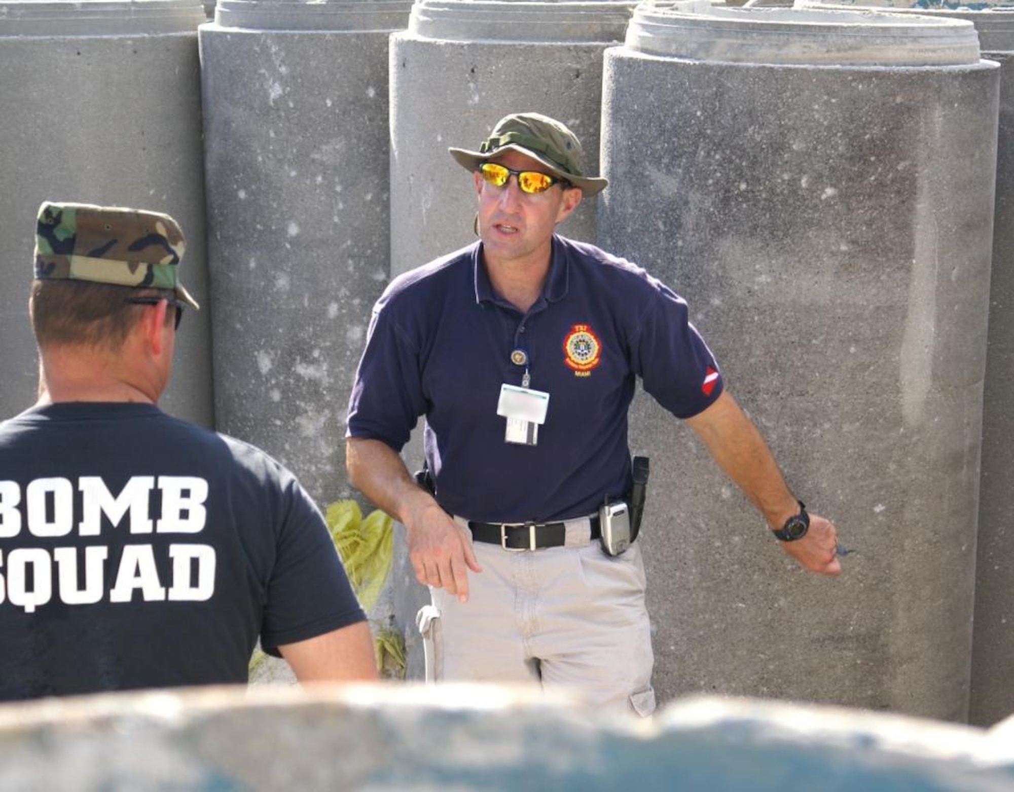 FBI Special Agent Scott Hahn explains the way to mark evidence for collection at a bombing scene to Master Sgt. James Raulerson, 482nd EOD program manager. The FBI taught South Florida crime scene investigators the same methods used by their organization to collect and preserve evidence during the FBI post-blast forensics training at Homestead Air Reserve Base, Fla. Nov 8 and 9. (U.S. Air Force photo/Dan Galindo) 