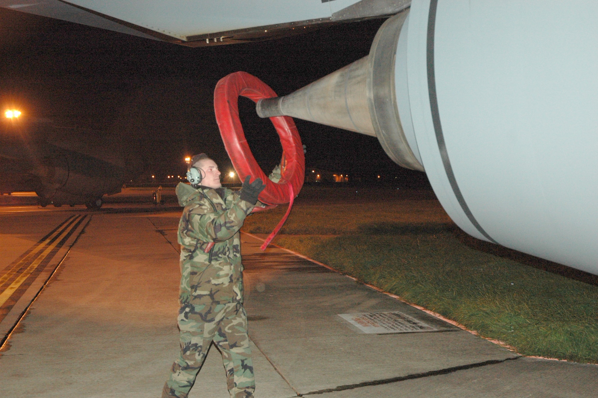 Staff Sgt. Justin Elder places protection covers on the engine of a 92nd Air Refueling Wing KC-135 Stratotanker deployed to Royal Air Force Mildenhall, England, Dec. 4. KC-135 aircrews, crew chiefs and maintainers from Fairchild Air Force Base, Wash., and Grand Forks AFB, N.D., are deployed RAF Mildenhall to augment its refueling wing. Sergeant Elder is a crew chief assigned to the 92nd Air Refueling Wing. (U.S. Air Force photo/Tech. Sgt. Scott Wakefield)