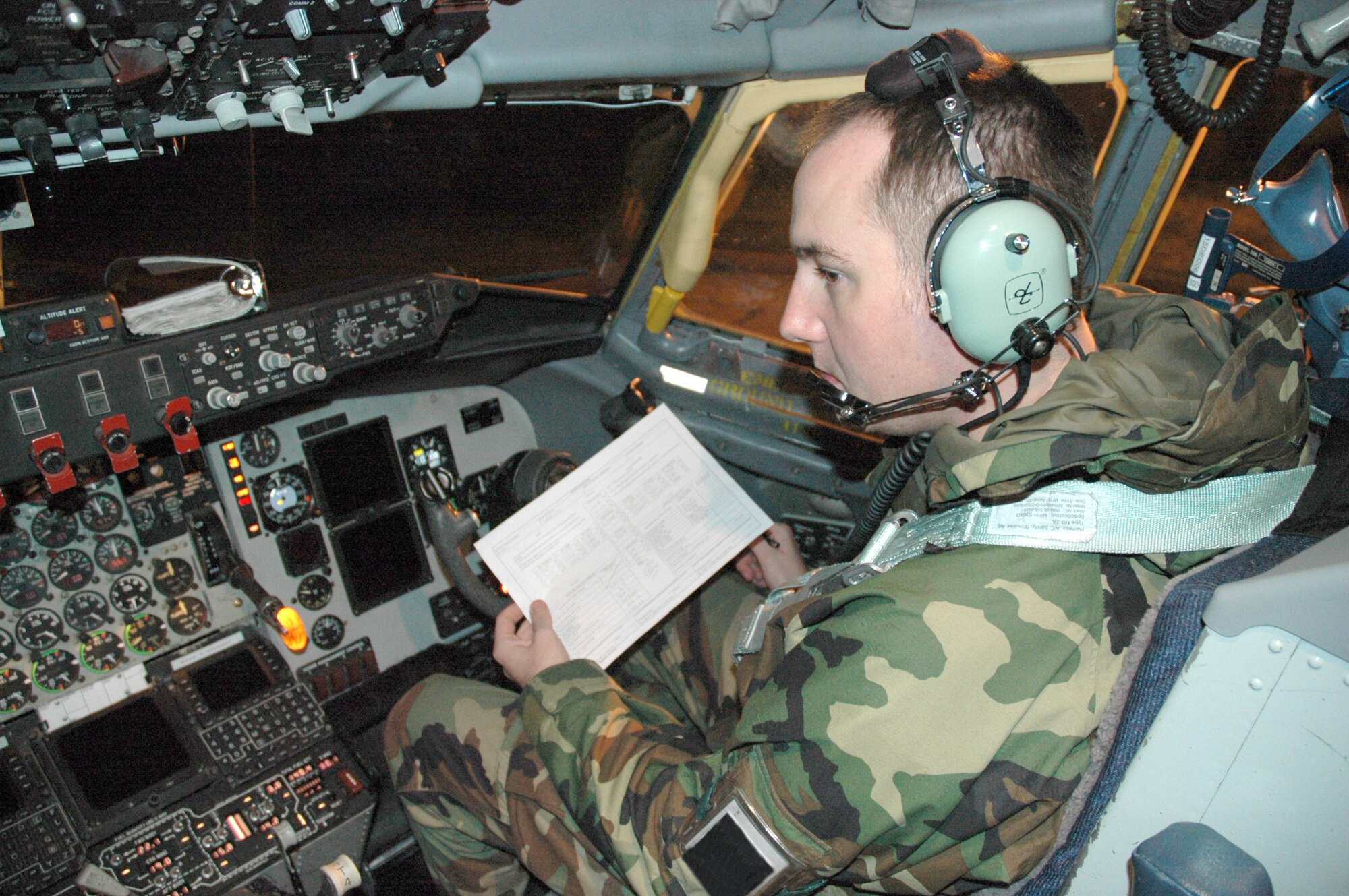 Senior Airman William Smith looks over a checklist to perform an engine run-up at Royal Air Force Mildenhall Dec. 4. KC-135 aircrews, crew chiefs and maintainers from Fairchild Air Force Base, Wash., and Grand Forks AFB, N.D., are deployed RAF Mildenhall to augment its refueling wing. Airman Smith is an avionics specialist assigned to the 92nd Air Refueling Wing. (U.S. Air Force photo/Tech. Sgt. Scott Wakefield)