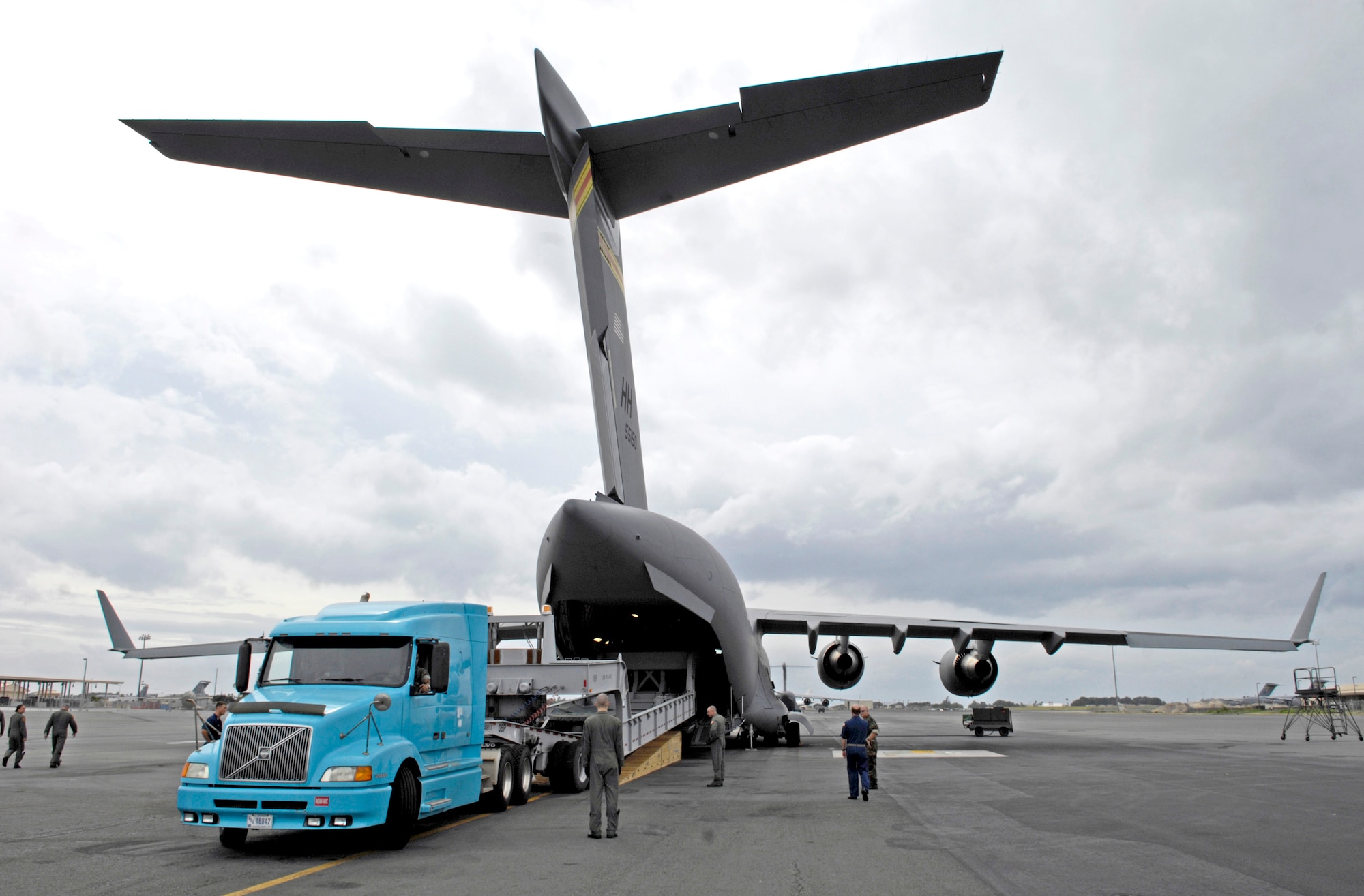 A dry dock transport vehicle is loaded on a C-17 Globemaster III Dec. 2 at Hickam Air Force Base, Hawaii. The flight was the first operational movement of a dry dock transport by a C-17. The aircraft is assigned to the 535th Airlift Squadron. (U.S. Air Force photo/Tech. Sgt. Shane A. Cuomo)