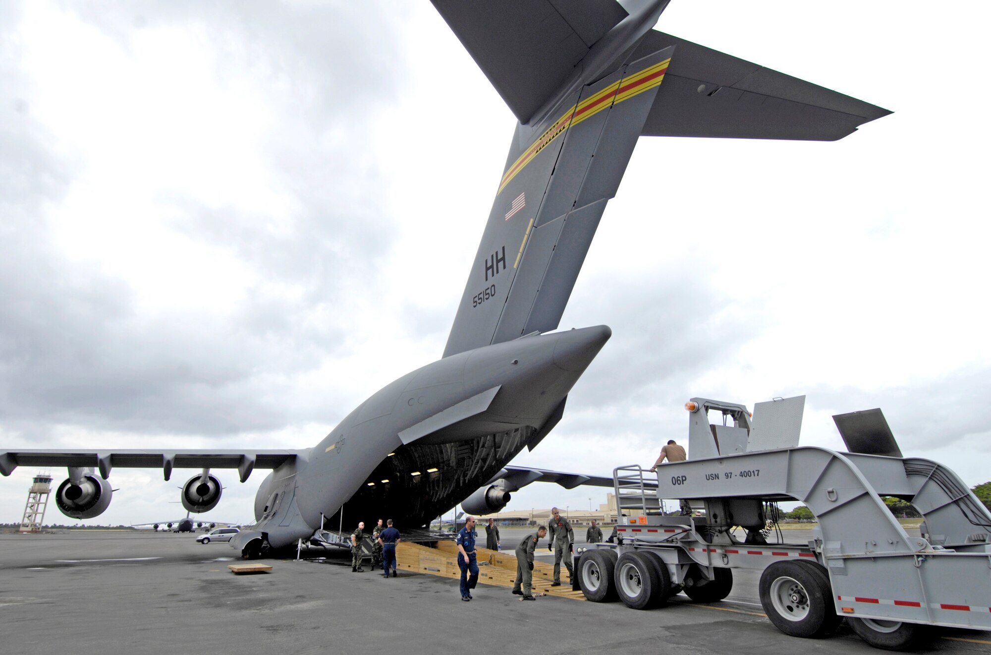A dry dock transport is loaded on a C-17 Globemaster III Dec. 2 at Hickam Air Force Base, Hawaii. The flight was the first operational movement of a dry dock transport by a C-17. The aircraft is assigned to the 535th Airlift Squadron. (U.S. Air Force photo/Tech. Sgt. Shane A. Cuomo)