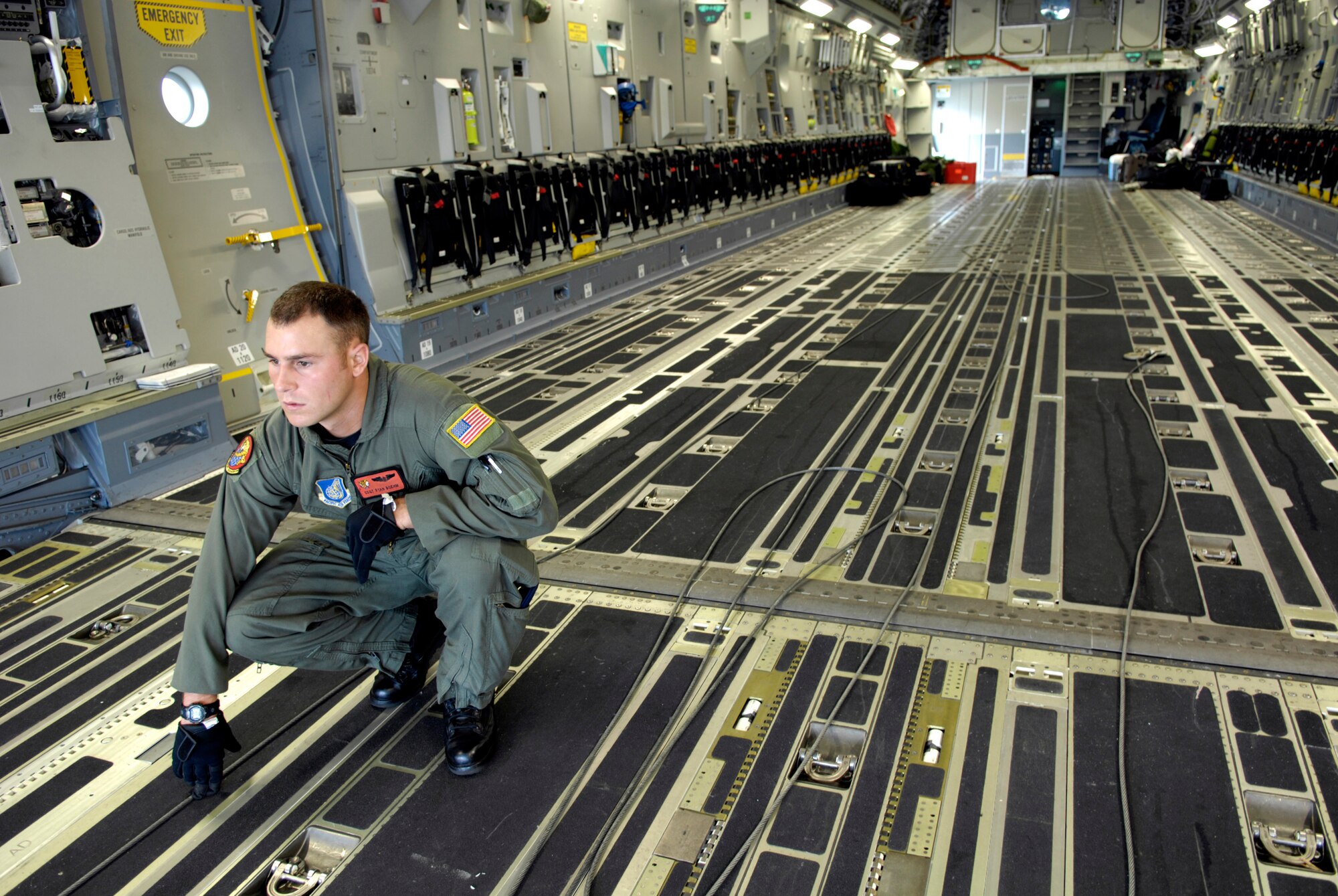Staff Sgt. Ryan Boehm visually lines up shoring to the ramp of his C-17 Globemaster III Dec. 2 at Hickam Air Force Base, Hawaii, in preparation for loading a dry dock transport vehicle. The flight was the first operational movement of a dry dock transport by a C-17. Sergeant Boehm is a loadmaster assigned to the 535th Airlift Squadron. (U.S. Air Force photo/Tech. Sgt. Shane A. Cuomo)