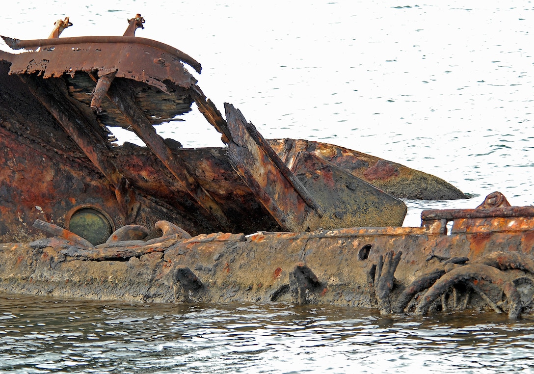 The rusted hull of the USS Utah remains in the water just off Ford Island. Three aerial torpedoes struck the USS Utah, causing the ship to sink during the 1941 attack of Pearl Harbor, Hawaii.  