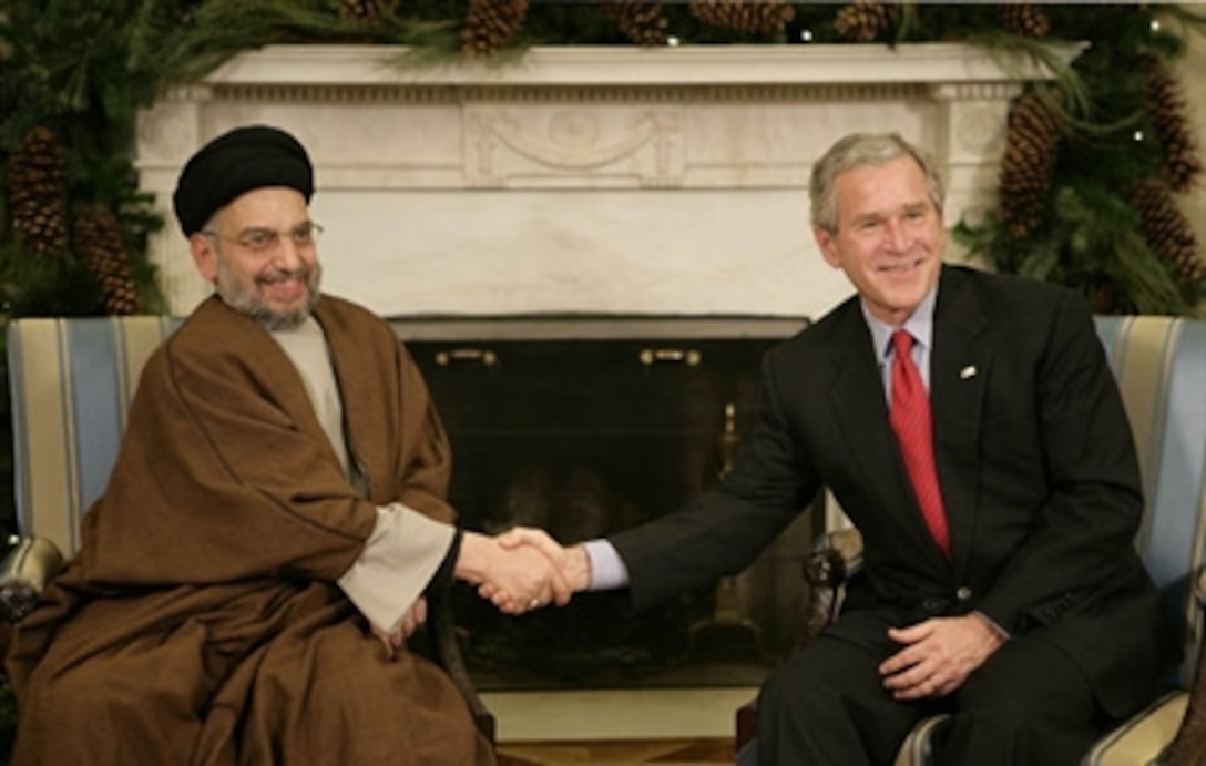 President George W. Bush welcomes Sayyed Abdul-Aziz Al-Hakim, leader of the Supreme Council for the Islamic Revolution in Iraq, to the White House Dec. 4, 2006. Bush said, " I appreciate so very much His Eminence's commitment to a unity government. I assured him the United States supports his work and the work of the Prime Minister to unify the country." 