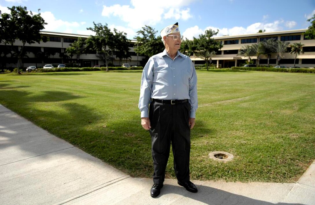 Retired Chief Master Sgt. Ralph Barnett stands in front of the Pacific Air Forces Headquarters building Dec. 4 at Hickam Air Force Base, Hawaii. The PACAF building was a consolidated barracks that then Sgt. Barnett lived in when it was attacked by the Japanese Dec. 7, 1941. Sergeant Barnett was the assistant armament chief for the 23rd Bombardment Squadron assigned to Hickam Field. (U.S. Air Force photo/ Tech. Sgt. Shane A. Cuomo)
