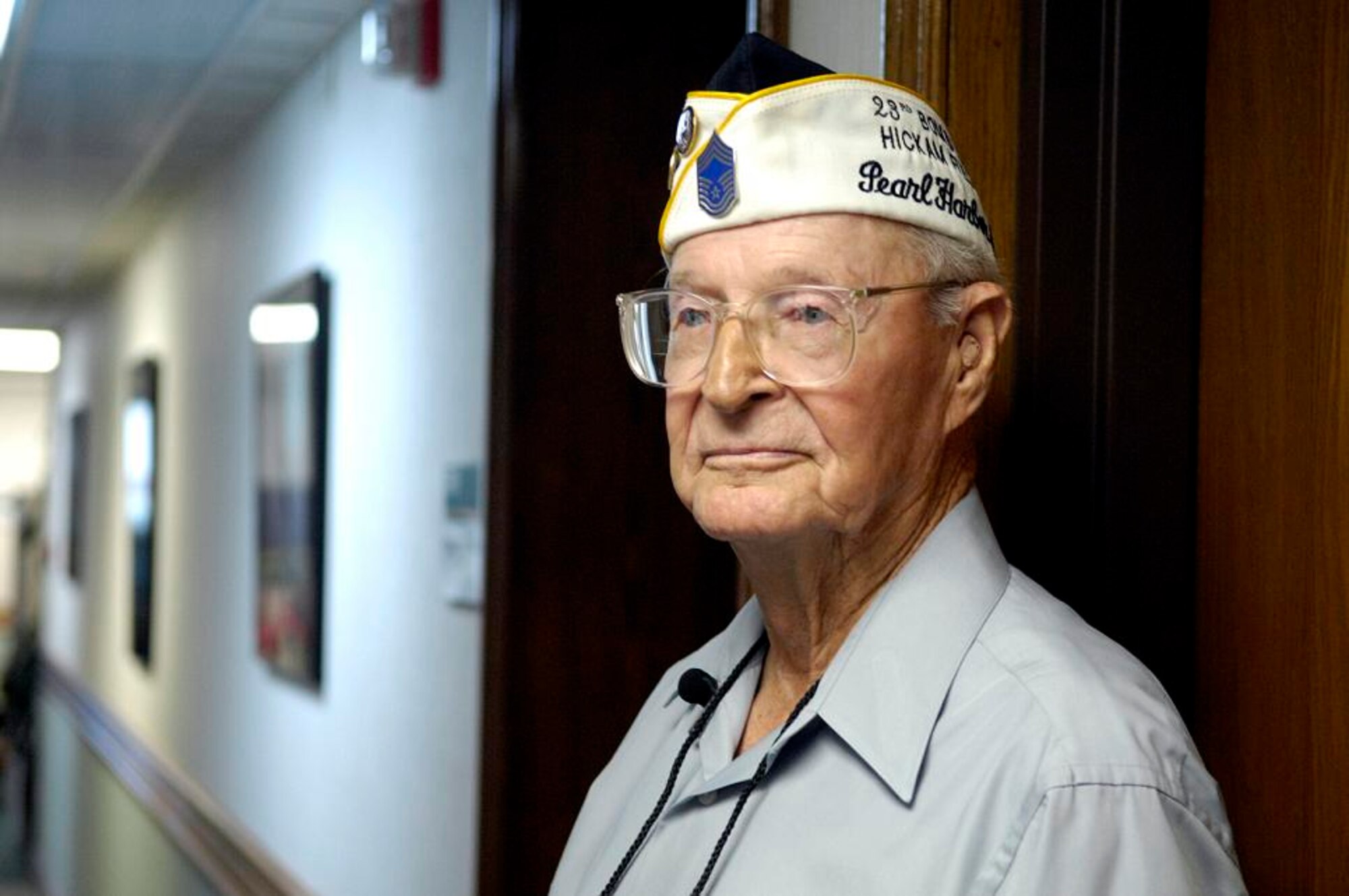 Retired Chief Master Sgt. Ralph Barnett stands in the hallway of the Pacific Air Forces Headquarters where he used to live Dec. 4, 2006 at Hickam Air Force Base, Hawaii. In 1941 the PACAF Headquarters was a consolidated barracks. Then Sgt. Barnett was the assistant armament chief for the 23rd Bombardment Squadron assigned to Hickam Field. (U.S. Air Force photo/ Tech. Sgt. Shane A. Cuomo)
