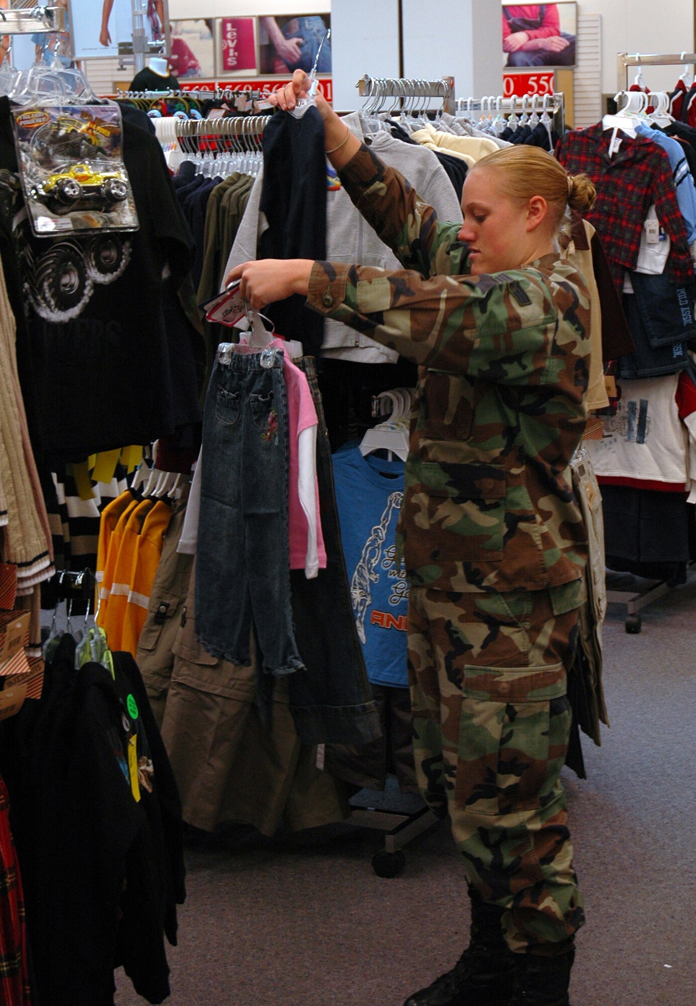 BUCKLEY AIR FORCE BASE, Colo. -- Senior Airman Stephanie Beal, 460th Civil Engineer Squadron, shops for gifts for children listed on the Angel Tree Dec. 6 at the Buckley Exchange. Team Buckley first sergeants and other volunteers spent approximately $4,600 donated by the Homefront Heroes Denver chapter, a non-profit military support group. The Angel Tree project provides family members of all services', E-5's and below, gifts for the holidays. (U.S. Air Force photo by Staff Sgt. Sanjay Allen)