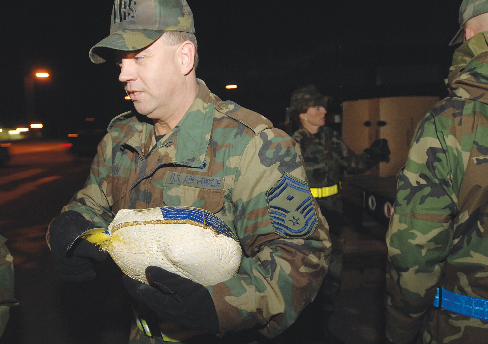 ELMENDORF AIR FORCE BASE, Alaska -- Senior Master Sgt. Patrick Julian, 3rd Logistics Readiness Squadron, loads turkeys in a truck to be delivered to families during Operation Warmheart. More than 220 boxes of food went out to nearly 800 military members and their families during the Operation Warmheart food drive put on by the base first sergeants. Each box included a 5-pound bag of potatoes, pie shells, gravy mix, cornbread and muffin mix, pudding and Jello, pumpkin pie and fruit filling, fruit cocktail, cranberry sauce, stuffing, sweet potatoes, suddenly salad and canned vegetables. Enough food was donated to double some of the food items in the boxes. The drive also raised enough food to donate about 750 pounds of potatoes to the Food Bank of Alaska. The Cub Scouts raised approximately $550 during the two-day drive at the Commissary.  (U.S. Air Force photo by Tech. Sgt. Keith Brown)