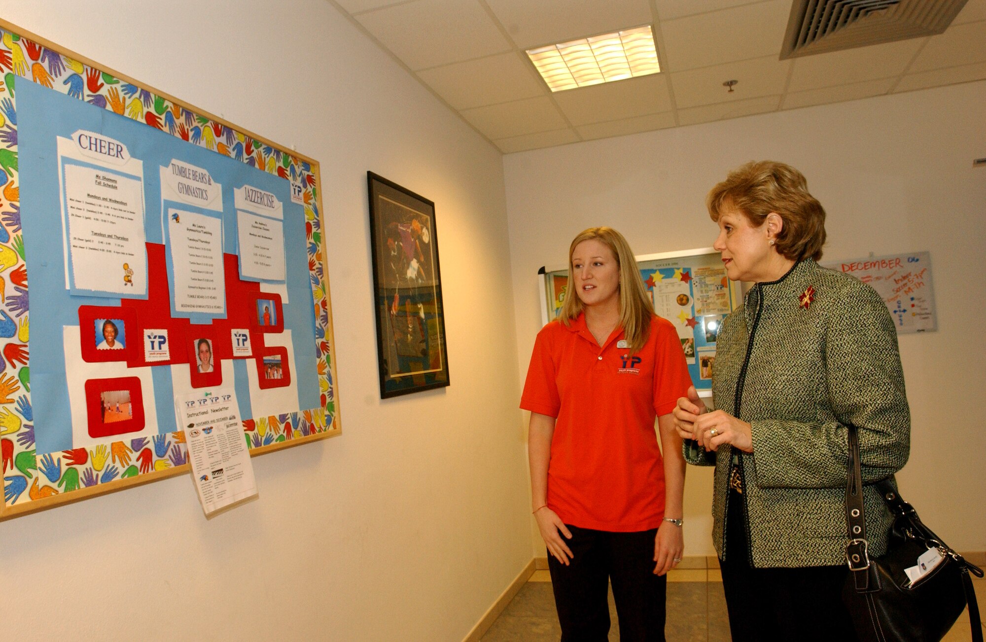 Shalee Torrence shows the different activities and programs offered to school aged children to Barbara Wynne Dec. 5 at Aviano Air Base, Italy. Secretary of the Air Force Michael W. Wynne and his wife are visiting with Airmen to get an orientation of the 31st Fighter Wing. Secretary Wynne is responsible for the affairs of the Department of the Air Force, and ensures the Air Force can meet its current and future operational requirements. Ms. Torrence is the base youth program manager. (U.S. Air Force photo/Airman 1st Class Nathan Doza) 
