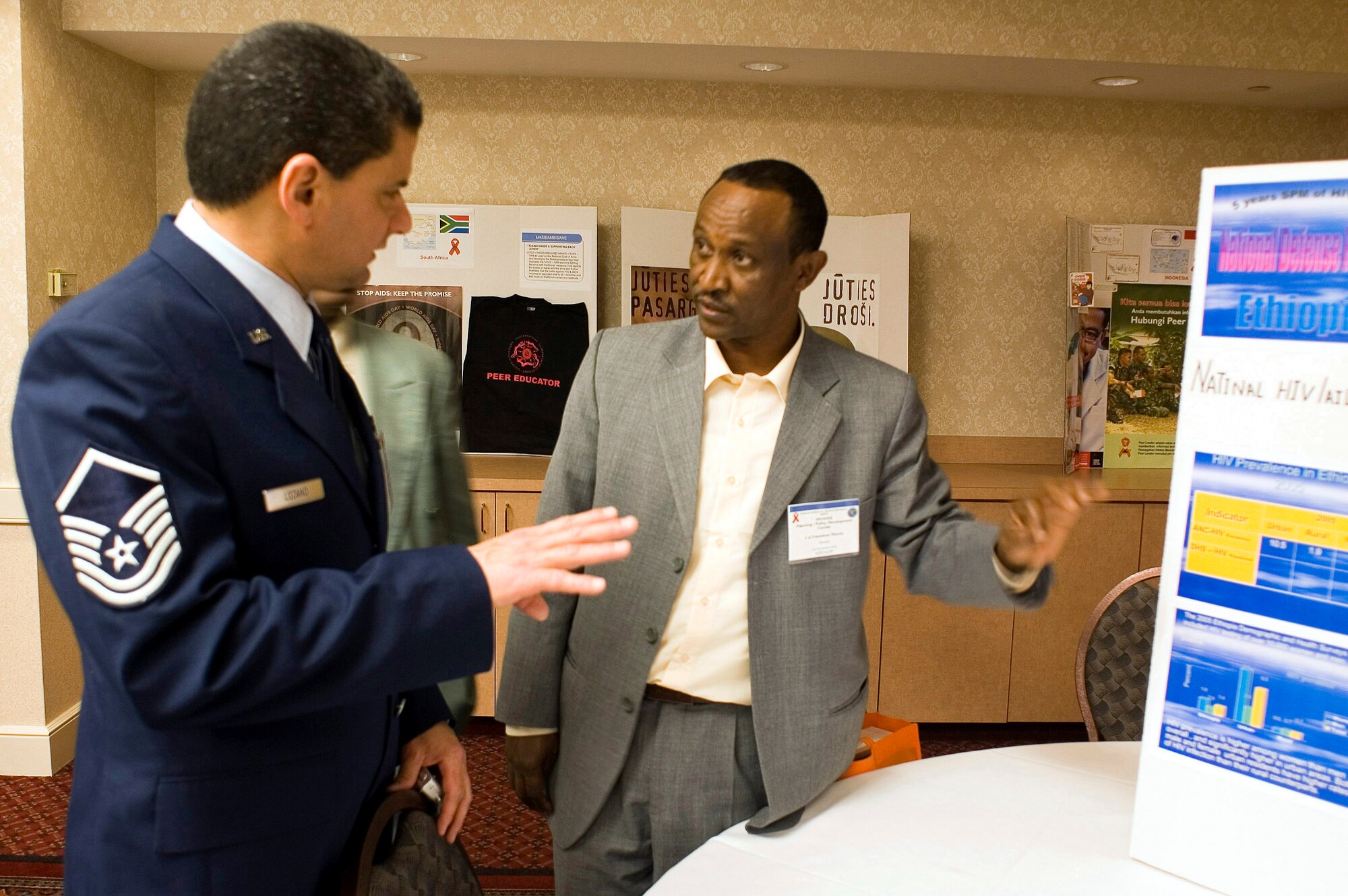 Master Sgt. Roy Lozano, Noncommisioned Officer In Charge of the International Health Specialist program at Ramstien Air Force Base, Germany, and Col. Fantahun Messele, Head of the HIV/AIDS Office in the Defense, Health Service Department, Ethiopia, review  Ethiopia AIDS/HIV statistics during the sixth annual international HIV/AIDS Conference in San Antonio, Texas, Dec. 5. The conference is designed to help senior military leaders from various nations develop and implement effective HIV/AIDS prevention strategies in their countries.(U.S. Air Force photo/Steve Thurow) 
