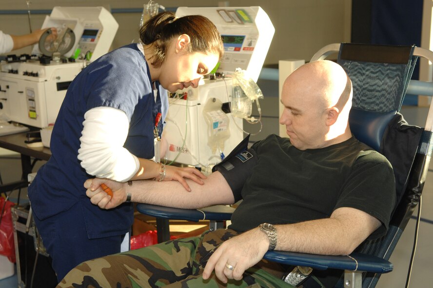 MINOT AIR FORCE BASE, N.D. --Tech. Sgt. John Gibson, 5th Maintenance Squadron, is being prepped for a blood donation by Adrianna Bueno, American Red Cross, during a blood drive at the McAdoo Sports and Fitness Center Wednesday. Sergeant Gibson is a regular blood donor. (U.S. Air Force photo by Airman 1st Class Christopher Boitz) 