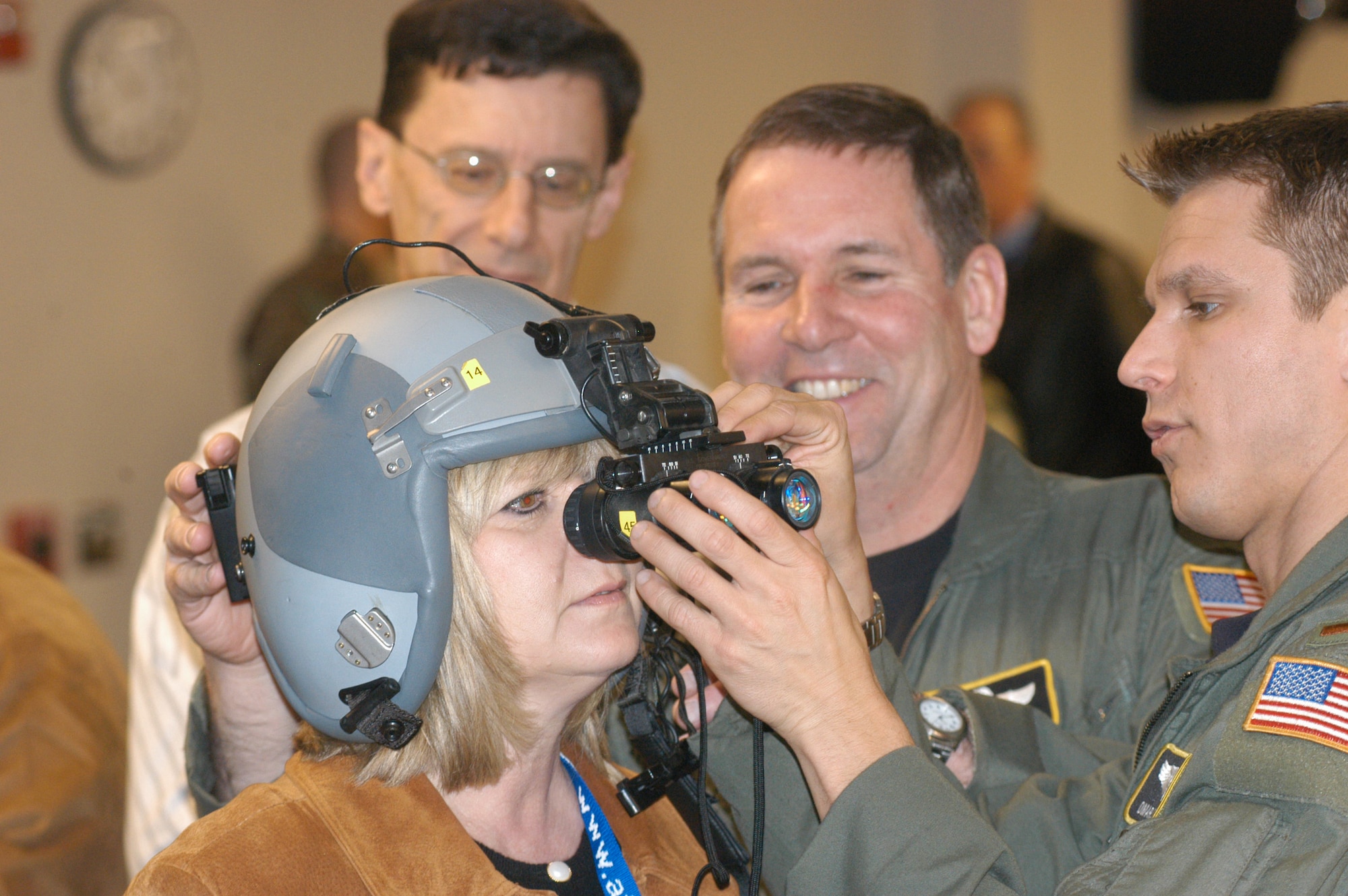 Lt. Col. Dan Gabler and 2nd Lt. Omar Stookey fit a pair of night vision goggles on Honorary Commander Vicki Painter during a tour of the 911th Airlift Wing, Air Force Reserve Command, March 16, 2006.