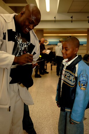 Bobby Lashley, a World Wrestling Entertainment, Inc. star signs a poster for Jamal Lucas, son of Senior Airman Jacquline Filbeck of the 437th Aerial Port Squadron at the Charleston Air Force Base, S.C., passenger terminal.  The 437th APS hosts the WWE stars and crew before a flight to Ramstein Air Base, Germany, Dec. 5, 2006. The WWE is performing for troops deployed overseas during a holiday tour put together by Armed Forces Entertainment. This will be the fourth time the WWE has teamed with Armed Forces Entertainment to entertain deployed troops.


(RELEASED)(U.S. Air Force photo by Airman 1st Class Nicholas Pilch)