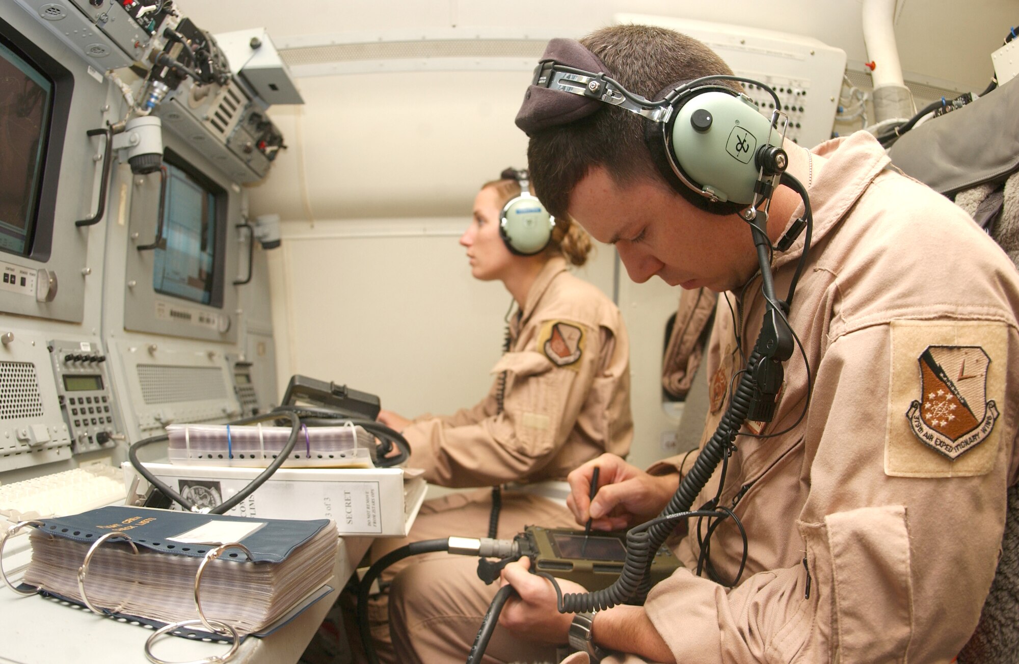 Staff Sgt. Mark Porter and Senior Airman Nicole LaGrow upload software onto an E-8C Joint STARS aircraft as they perform radio and computer checks in preparation for a flight. Both Airmen are assigned to the 12th Expeditionary Airborne Command and Control Squadron. The flight over Iraq marked 20,000 flying hours in support of Operation Iraqi Freedom by the Boeing 707 equipped with the Joint Surveillance Target Attack Radar System. Accomplishing that feat since early 2003 have been the combined efforts of the 12th EACCS, 16th EACCS and 128th EACCS, all from Robins Air Force Base, Ga., during alternating 90-day rotations. The JSTARS is an airborne battle management aircraft specializing in command and control, and intelligence, surveillance and reconnaissance gathering. Information gathered is passed in real time to servicemembers on the ground conducting combat operations. (U.S. Air Force photo/Senior Airman Ricky Best)
