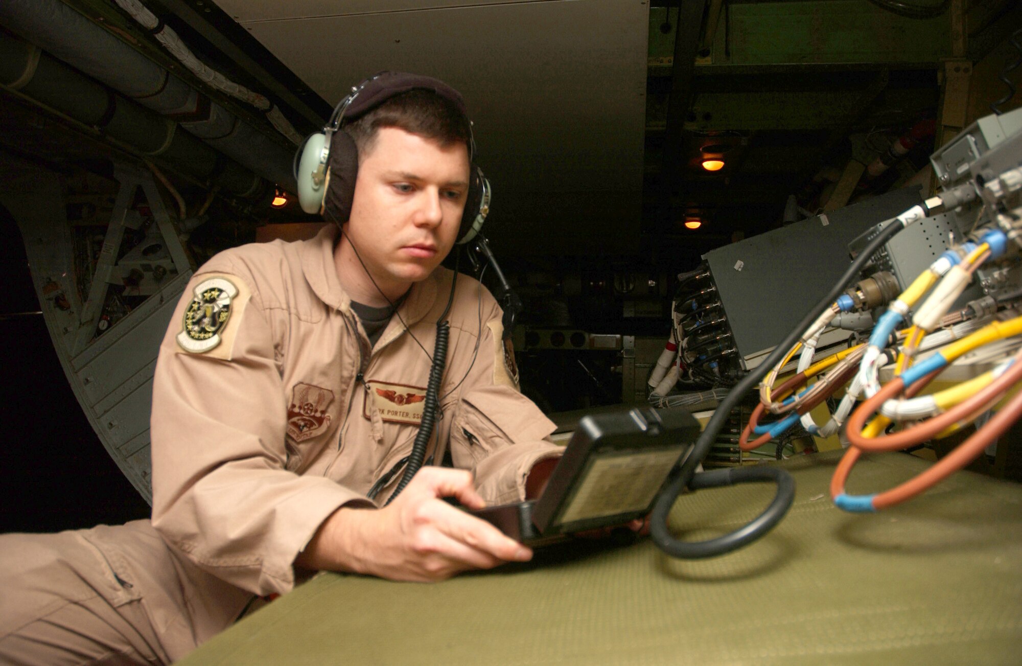 Staff Sgt. Mark Porter uploads radio software onto an E-8C Joint STARS aircraft prior to departure Nov. 30 in Southwest Asia. Sergeant Porter is assigned to the 12th Expeditionary Airborne Command and Control Squadron. The flight over Iraq marked 20,000 flying hours in support of Operation Iraqi Freedom by the Boeing 707 equipped with the Joint Surveillance Target Attack Radar System. Accomplishing that feat since early 2003 have been the combined efforts of the 12th EACCS, 16th EACCS and 128th EACCS, all from Robins Air Force Base, Ga., during alternating 90-day rotations. The JSTARS is an airborne battle management aircraft specializing in command and control, and intelligence, surveillance and reconnaissance gathering. Information gathered is passed in real time to servicemembers on the ground conducting combat operations. (U.S. Air Force photo/Senior Airman Ricky Best)