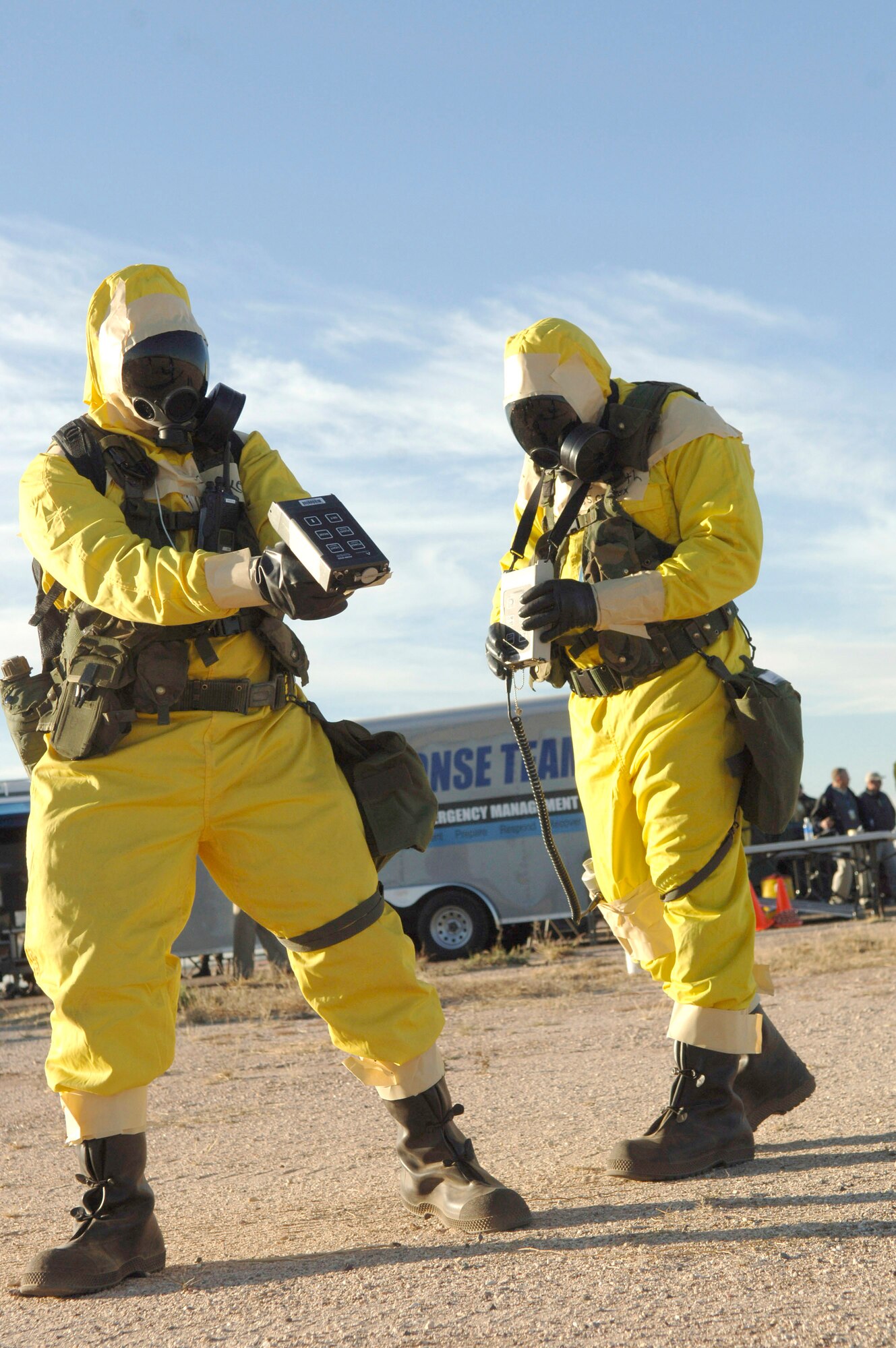 Airmen 1st Class Bryan Keith and Lawrence Ackerman check the area for contamination prior to setting up the contamination control station Dec. 4 at Davis-Monthan Air Force Base, Ariz., during Vigilant Shield 07. Vigilant Shield 07 is a joint nuclear weapon accident exercise designed to train Department of Defense and federal agencies on response efforts as a cohesive team. (U.S. Air Force photo/Senior Airman Christina D. Ponte)