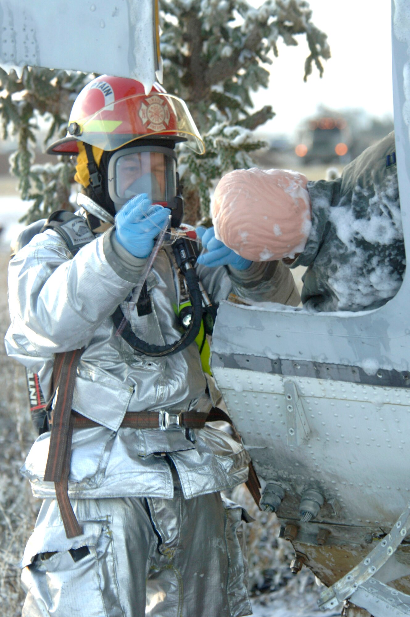 A firefighter assesses the condition of a simulated survivor found at the scene of an aircraft accident Dec. 4 at Davis-Monthan Air Force Base, Ariz., during Vigilant Shield 07. Vigilant Shield 07 is a joint nuclear weapon accident exercise designed to train Department of Defense and federal agencies on response efforts as a cohesive team. The exercise involved a variety of agencies representing the county, state and federal governments. (U.S. Air Force photo/Senior Airman Christina D. Ponte)