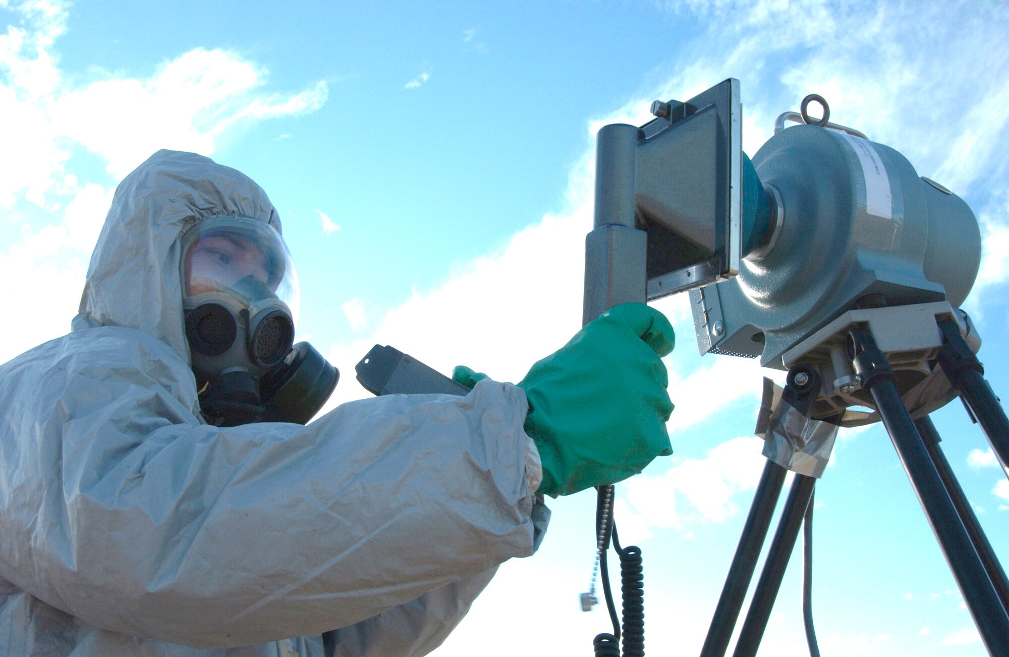 Staff Sgt. Xavier Goco monitors radiation levels and tests for potential contamination using a high volume air sampling monitor and an ADM-300 at a simulated aircraft crash site on Davis-Monthan Air Force Base, Ariz., Dec. 4 during Vigilant Shield 07. Vigilant Shield 07 is a joint nuclear weapon accident exercise designed to train Department of Defense and federal agencies on response efforts as a cohesive team. The exercise involved a variety of agencies representing the county, state and federal governments. Sergeant Goco is assigned to the 355th Aerospace Medicine Squadron. (U.S. Air Force photo/Airman 1st Class Alesia Goosic)