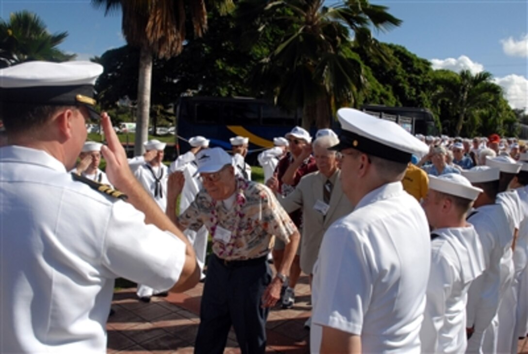 USS Arizona survivor Vincent Vlach renders a salute as he reaches the head of a ceremonial cordon during an event at the USS Arizona Memorial Visitor's Center, at Pearl Harbor, Hawaii, Dec. 5, 2006. 