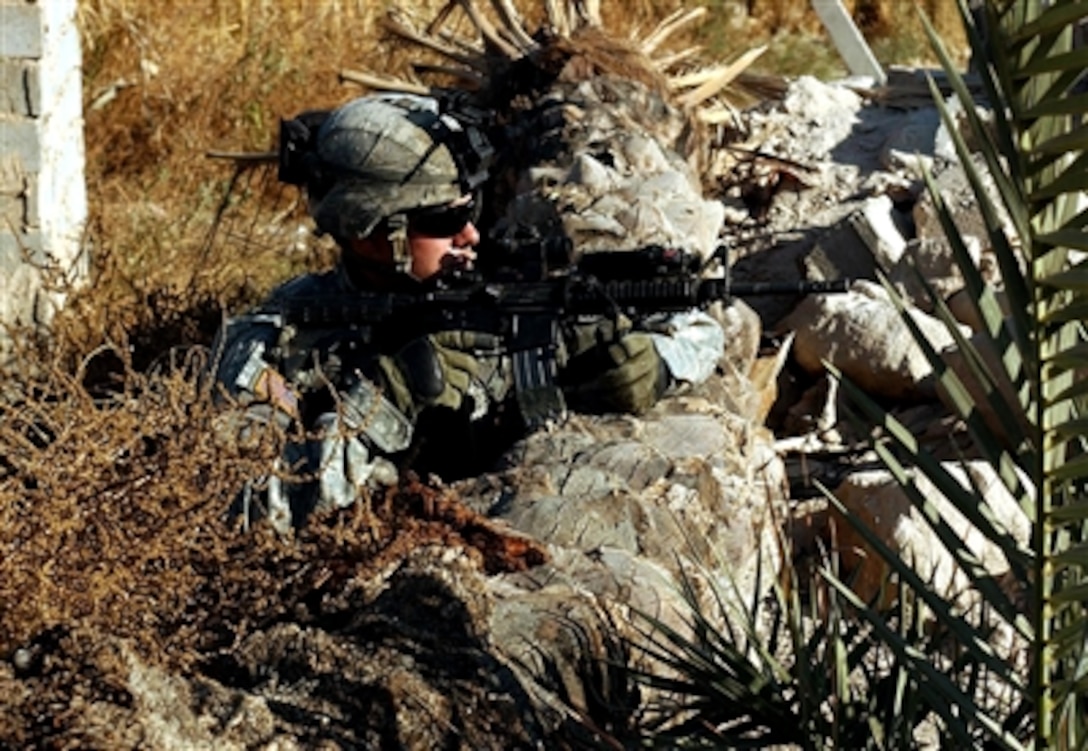 U.S. Army Pfc Casey Blackwell, from the 40th Cavalry Regiment, pulls security during a route clearance patrol outside of Baghdad, Iraq, Nov 30, 2006. The unit is providing security as a road crew repairs damage created by improvised explosive devices.