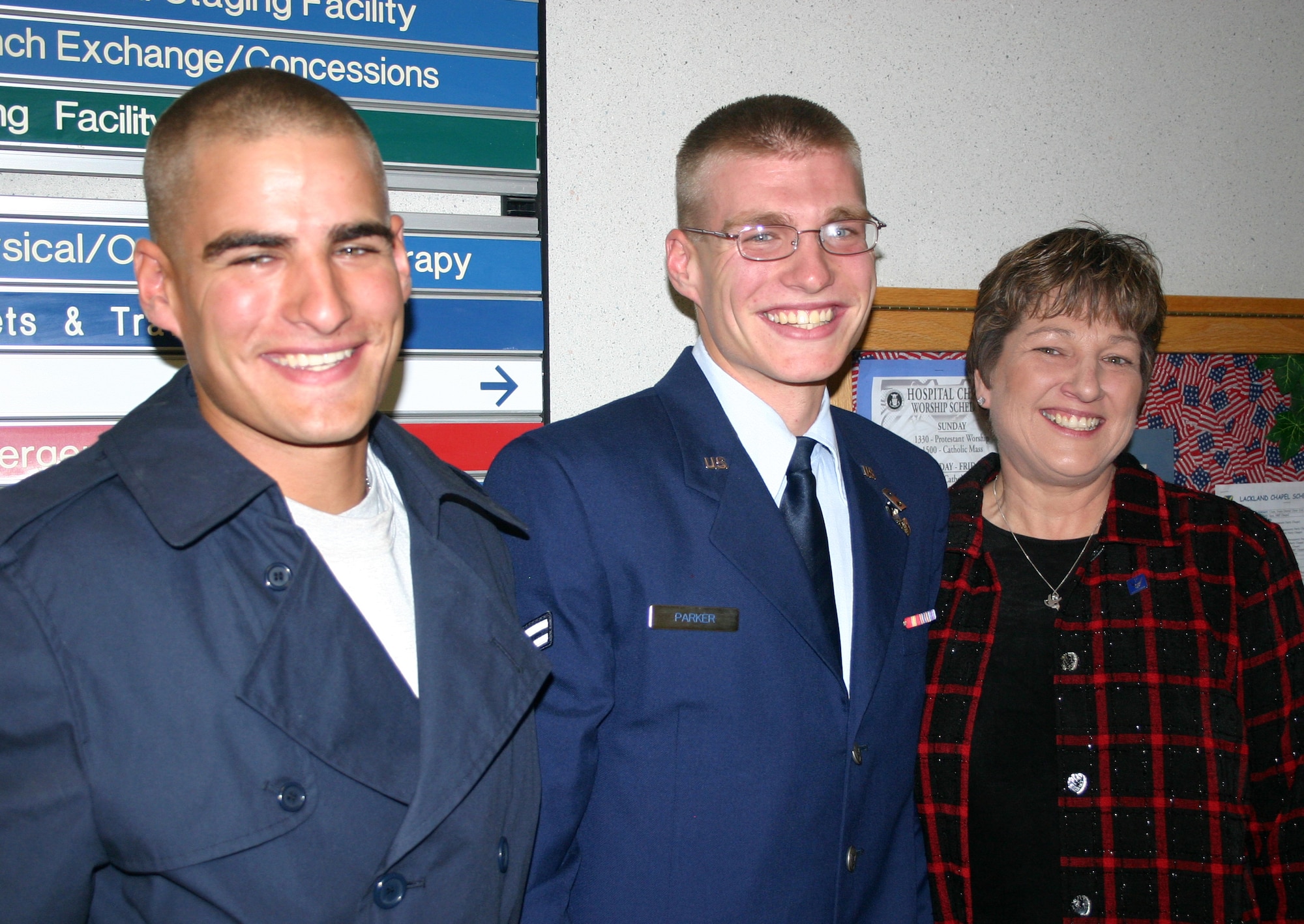 Airman 1st Class David Parker (left), an Aeromedical Services Apprentice Phase II student here at Wilford Hall Medical Center, was not expecting to see his mother, Cathie Parker (right), and brother, Jonathan Parker, at his graduation ceremony held in the 59th Medical Wing Chapel Wednesday. The surprise was obvious on the young Airman's face as he was seated one row in front of his family during the ceremony. The surprise was coordinated by his military training leader, Master Sgt. Richard Righetti, and Mrs. Parker. (U.S. Air Force photo/Master Sgt. Kimberly Spencer) 