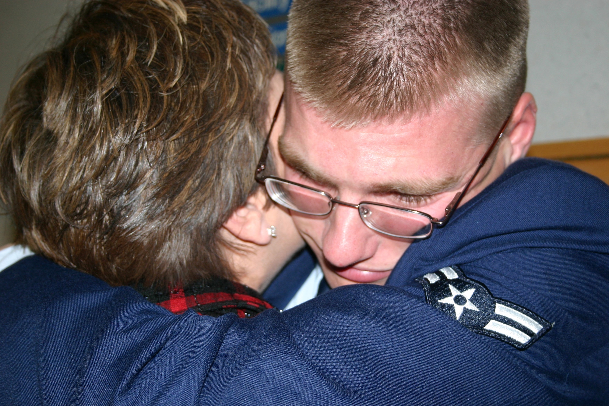 0612006-6155S-002 
Airman Basic David Parker hugs mom, Cathie Parker, in an emotional surprise reunion following his graduation from the Aeromedical Services Apprentice Phase II Student Course here at Wilford Hall Medical Center Wednesday. Airman Parker did not know his mother and brother would be at his graduation ceremony until he marched into the room and saw them in attendance. The surprise was coordinated by his military training leader and mother. (U.S. Air Force photo/Master Sgt. Kimberly Spencer) 