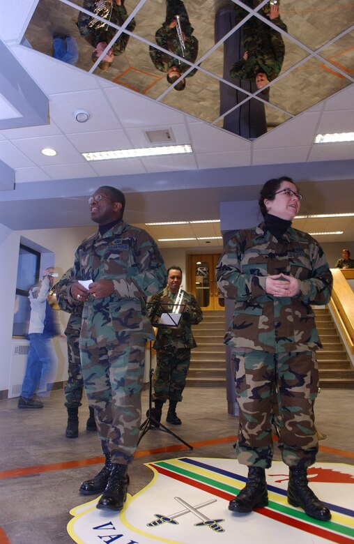 EIELSON AIR FORCE BASE, Alaska -- Members of the PACAF Alaska Brass Quintet's vocalist sing Christmas songs Dec. 6 at the 354th Fighter Wing headquarters building. (U.S. Air Force photo by Senior Airman Anthony Nelson.)