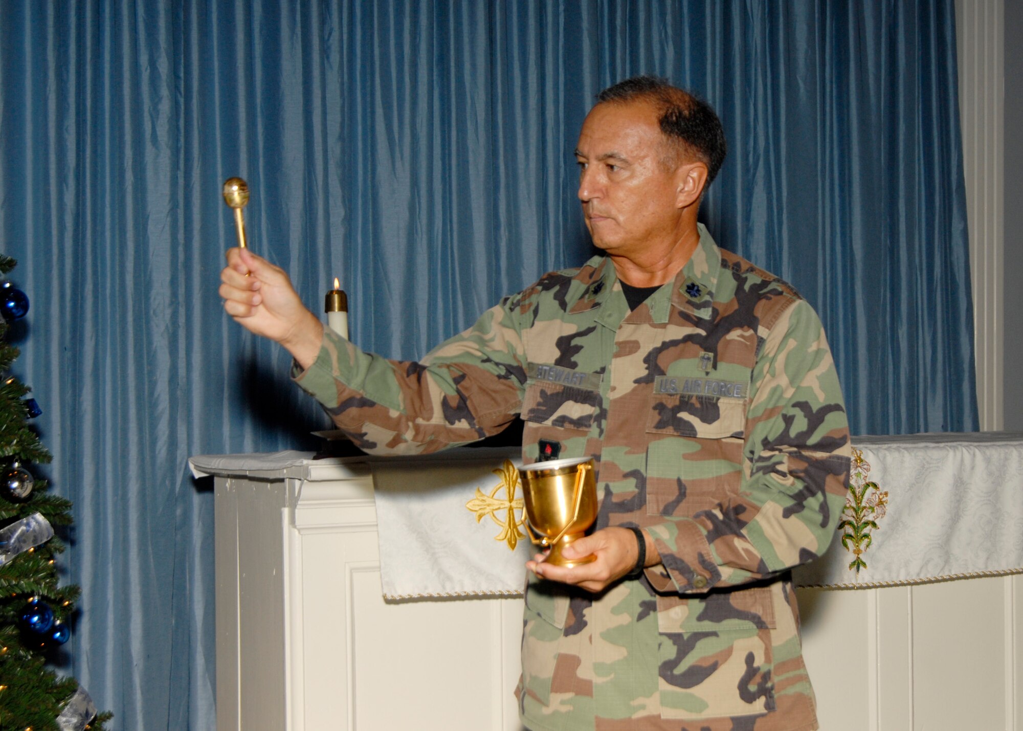 TYNDALL AIR FORCE BASE, Fla. --  Chaplain (Lt. Col.) Paul Stewart, 325th Fighter Wing chaplain, blesses the altar during the Chapel 1 rededication ceremony Dec. 1. The chapel closed Jan. 16 for renovation and reopened officially 9:30 a.m. Nov. 5 for weekly Sunday Liturgical Service. (U.S. Air Force photo by Isaac Gibson)