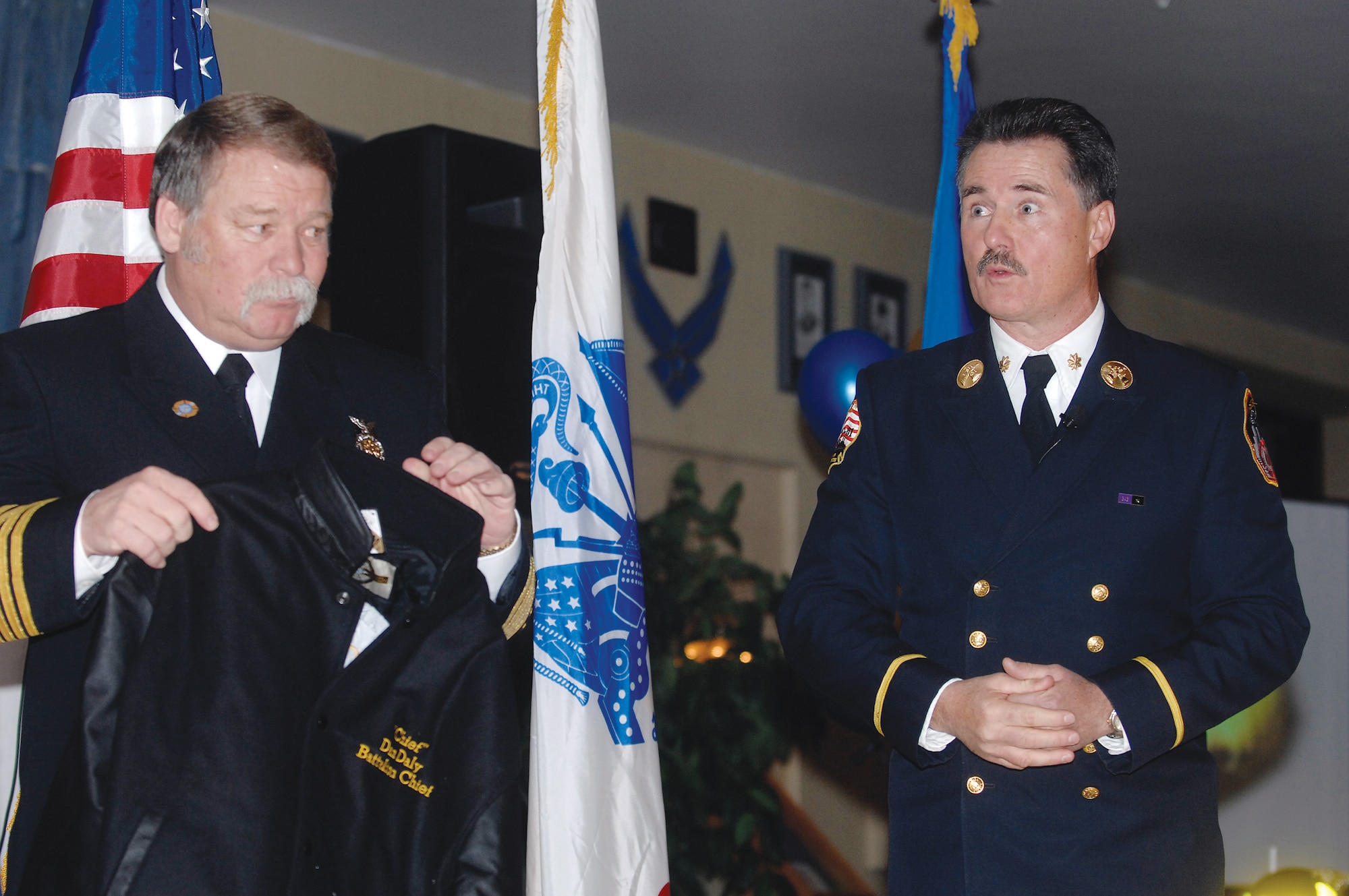Joint Base Elmendorf and Richardson Fire and Emergency Services Fire Chief William Bennyhoff presents a gift on behalf of the JBER Fire and Emergency Services, to retired New York battalion fire chief and guest speaker Dan Daly as a token of appreciation.
Chief Daly was the guest speaker at the 13th Annual Firefighter's Ball at The Susitna Club Nov. 18.
(U.S. Air Force photo by Airman 1st Class Jonathan Steffan)