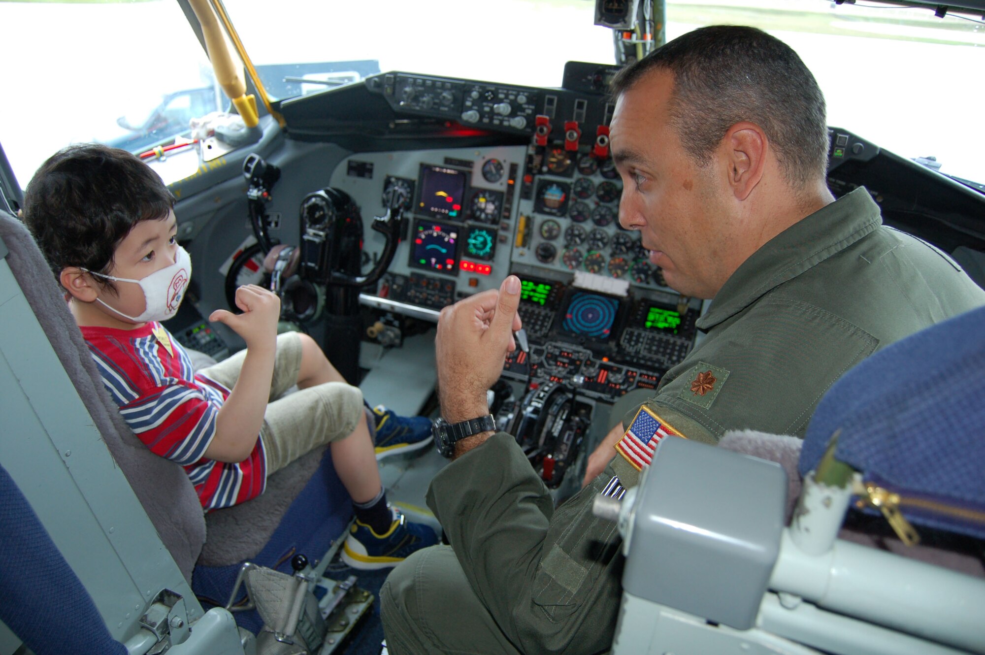 Maj. Jerry Malloy shows 5-year-old Natsuki Takeda the cockpit of a KC-135 Stratotanker Dec. 5 at Andersen Air Force Base, Guam. Andersen AFB members teamed up with the Make-A-Wish Foundation of Guam to grant Natsuki's wish of seeing a military aircraft. Major Maloy is a a KC-135 instructor pilot with the 506th Expeditionary Air Refueling Squadron. (U.S. Air Force photo/Master Sgt. Ann Bennett)
