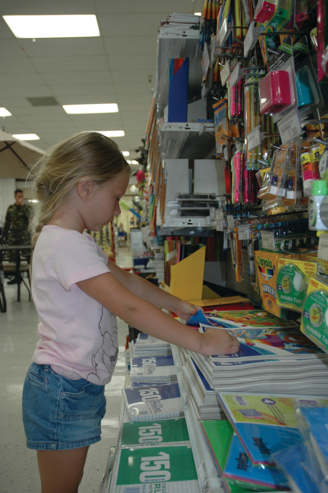 TYNDALL AIR FORCE BASE, Fla. --  Gabrielle Rainey picks out a colored paper notebook for class. School begins Wednesday for Tyndall Elementary school students. (U.S. Air Force photo by Staff Sgt. Stacey Haga)