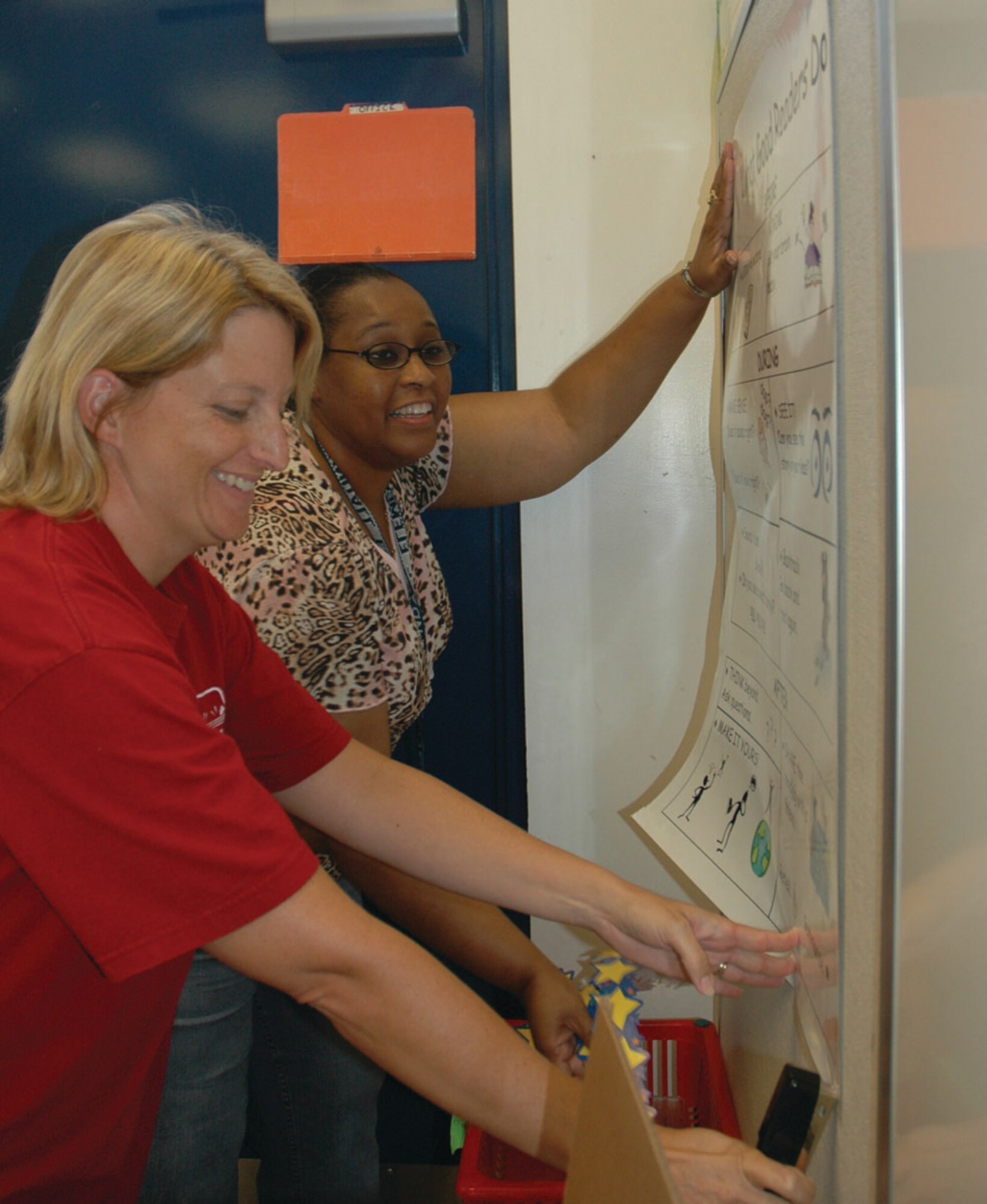 TYNDALL AIR FORCE BASE, Fla. -- Julie Weston, Tyndall Elementary 5th grade teacher, and Dra Phillips, 4th grade teacher, put together a bulletin board for Mrs. Phillips classroom. (U.S. Air Force photo by Staff Sgt. Stacey Haga)