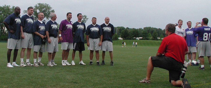 Pro Bowler and a Super Bowl MVP, quarterback Kurt Warner (in purple jersey), meets the 932nd Airlift Wing, Air Force Reserve team, after the competition.  Flag football out at Rams Park involved inviting members of the 932nd Airlift Wing to play in Kurt Warner's foundation, First Things First Ultimate Football event.  The Air Force Reservists were able to "draft" Marc Bulger to be their quarterback for the competition.
