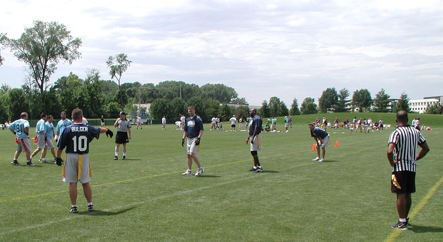 Senior Master Sgt. Todd Wadkins directs a play just before the clock starts.  Flag football out at Rams Park involved inviting members of the 932nd Airlift Wing to play in Kurt Warner's foundation, First Things First Ultimate Football event.  The Air Force Reservists were able to "draft" Marc Bulger to be their quarterback for the competition.