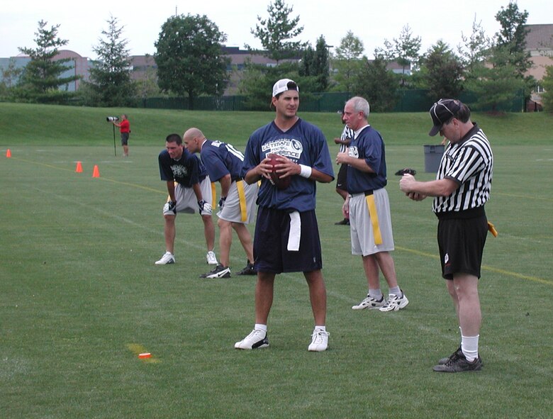 Pro Bowl St. Louis Rams quarterback Marc Bulger gets ready to throw the "long bomb" to an Air Force Reservist.  Flag football at Rams Park brought members of the 932nd Airlift Wing to play in Kurt Warner's foundation, First Things First Ultimate Football event.  The Air Force Reservists were able to "draft" Marc Bulger to be their quarterback for the competition.