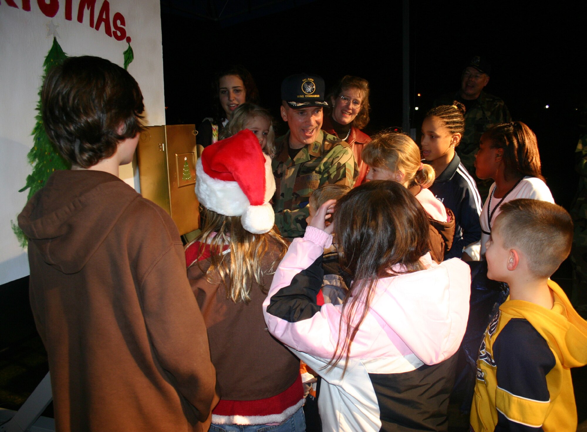 Col. Rick Martin, 305th Air Mobility Wing commander, along with children of deployed Team McGuire members, count down during the tree lighting ceremony at the Chapel 1 Annex here Nov. 29. The colonel invited all children who had a parent deployed up to the stage to help him pull the lever to light the McGuire Christmas tree. A band entertained the group with holiday songs while hot chocolate and cookies were served, and Santa came and delivered toys to the children. U.S. Air Force photo by Airman Rebekah Phy
