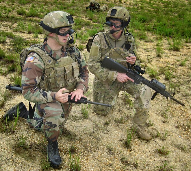 Army Spc. Chad Tobin (left) and Staff Sgt. Stephan Simmins participated in an On-The-Move training exercise in June at Fort Dix, N. J. The exercise featured Air Force technology applied to support the Army’s Future Force Warrior concept, including a goggle-mounted display, a hand-held mouse that activates push-to-talk PC voice command software, a backpack PC and power system, and rifle-mounted laser range finder. (Photo by David Darkow, 670 AESS)