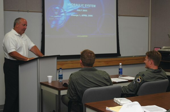 TYNDALL AIR FORCE BASE, Fla. --  Don Muller teaches hydraulic systems to 2nd Fighter Squadron B-course students during their first week of training. (U.S. Air Force photo by Chrissy Cuttita)