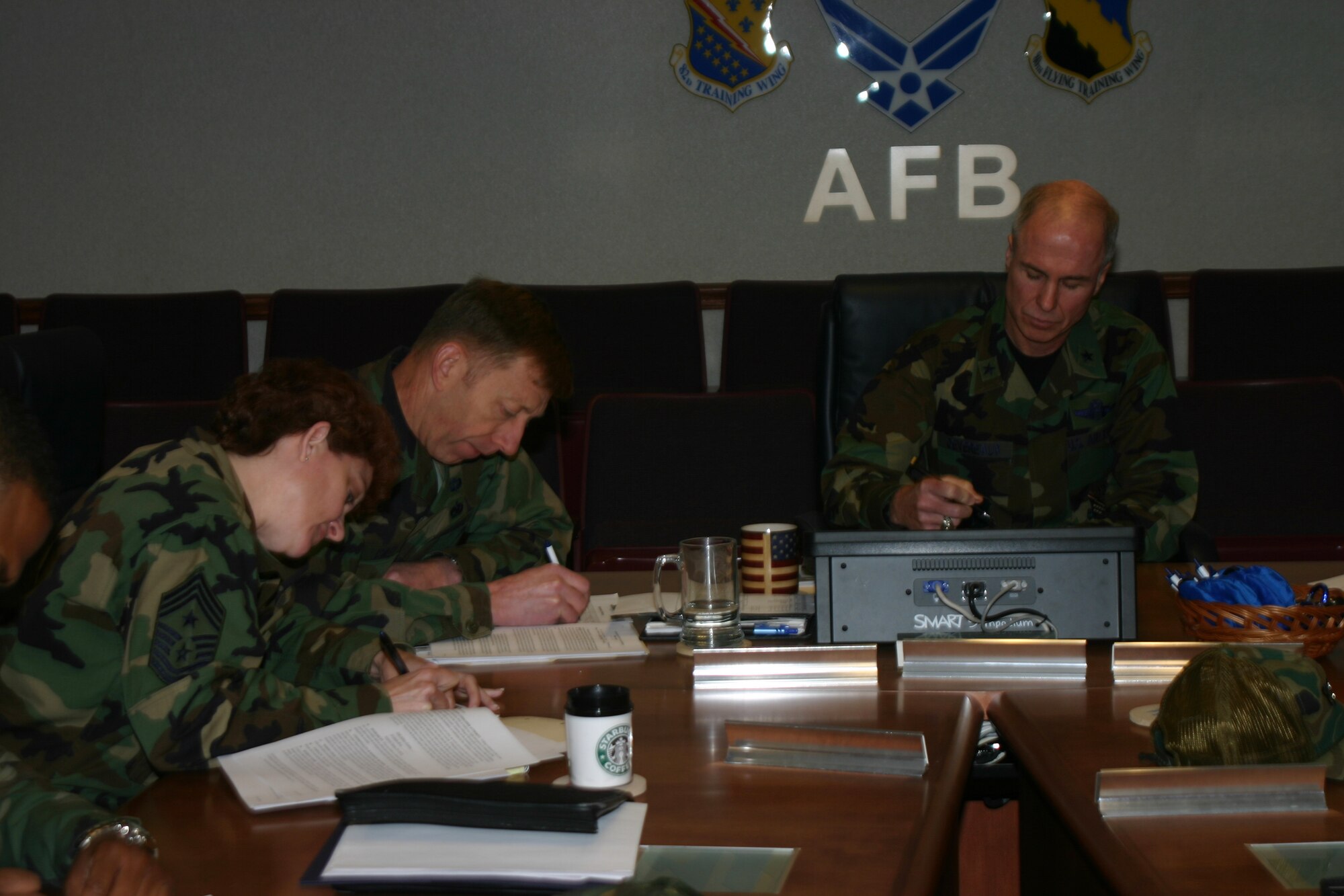 Brig. Gen. Richard Devereaux, 82nd Training Wing commander, right, Vice Commander Col. Lansen Conley and Chief Master Sgt. Jeannie McLean, the wing’s command chief master sergeant, lead the way for Sheppard as housing residents signed housing leases with GMH Military Housing this week. GMH was selected as the contract that would usher Sheppard into the housing privatization initiative. (U.S. Air Force photo/Airman Jacob Corbin.)