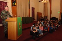 MINOT AIR FORCE BASE, N.D. -- Col. Eldon Woodie, 5th Bomb Wing commander, addresses the base community at the Northern Lights Chapel Dec. 1 shortly before the base Christmas tree-lighting ceremony. Before the ceremony there was caroling, refreshments and children spent time with Santa Claus. (U.S. Air Force photo by Airman 1st Class Cassandra Butler)