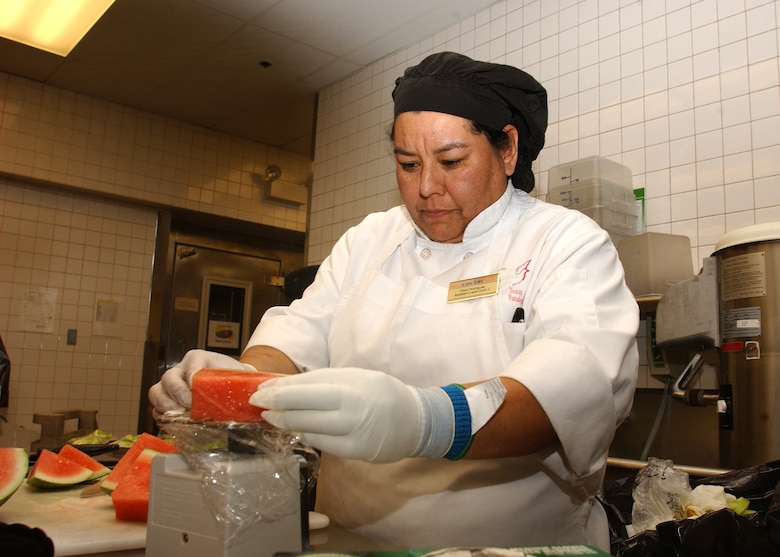 Cheri Rodriguez, a 30th Services Division lead cook, weighs watermelon at Breakers Dining Facility on Vandenberg AFB.  Weighing food ensures overserving and excessive food costs are reduced. (U.S. Air Force photo by Airman Adam Guy) 