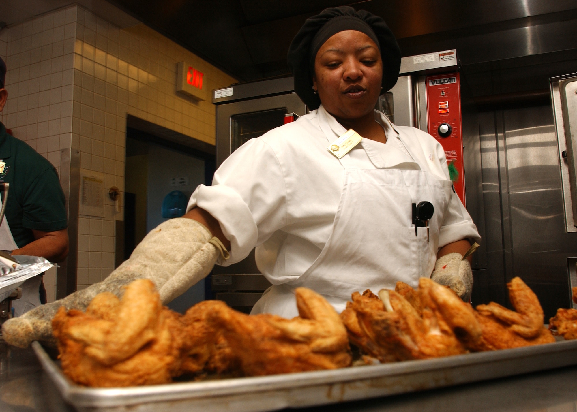Betty Conley, a 30th Services Division lead cook, prepares chicken at Breakers Dining Facility on Vandenberg AFB.  Food preparation starts early each day to ensure freshness and quantity requirements are met before serving. (U.S. Air Force photo by Airman Adam Guy)